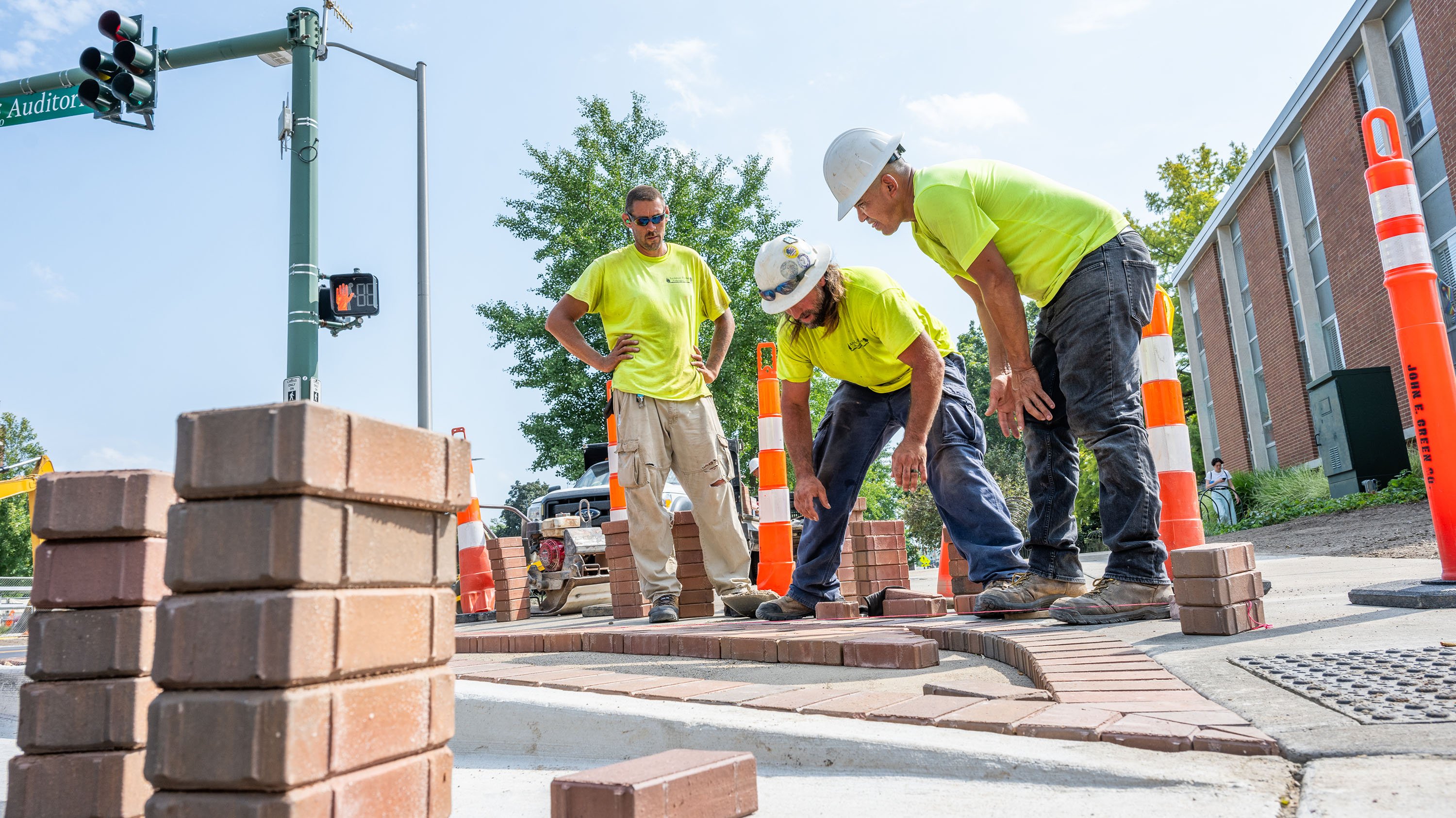 IPF crew members doing brickwork on sidewalk