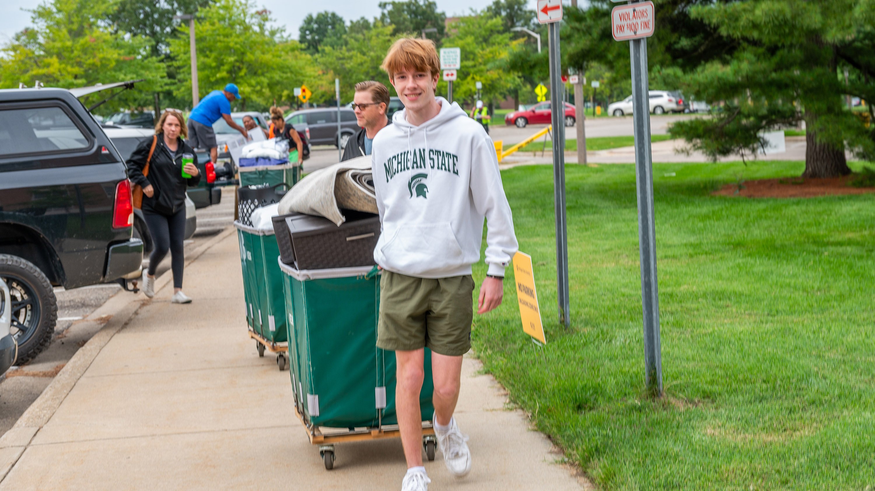 Student pulling a laundry cart during residence hall move-in