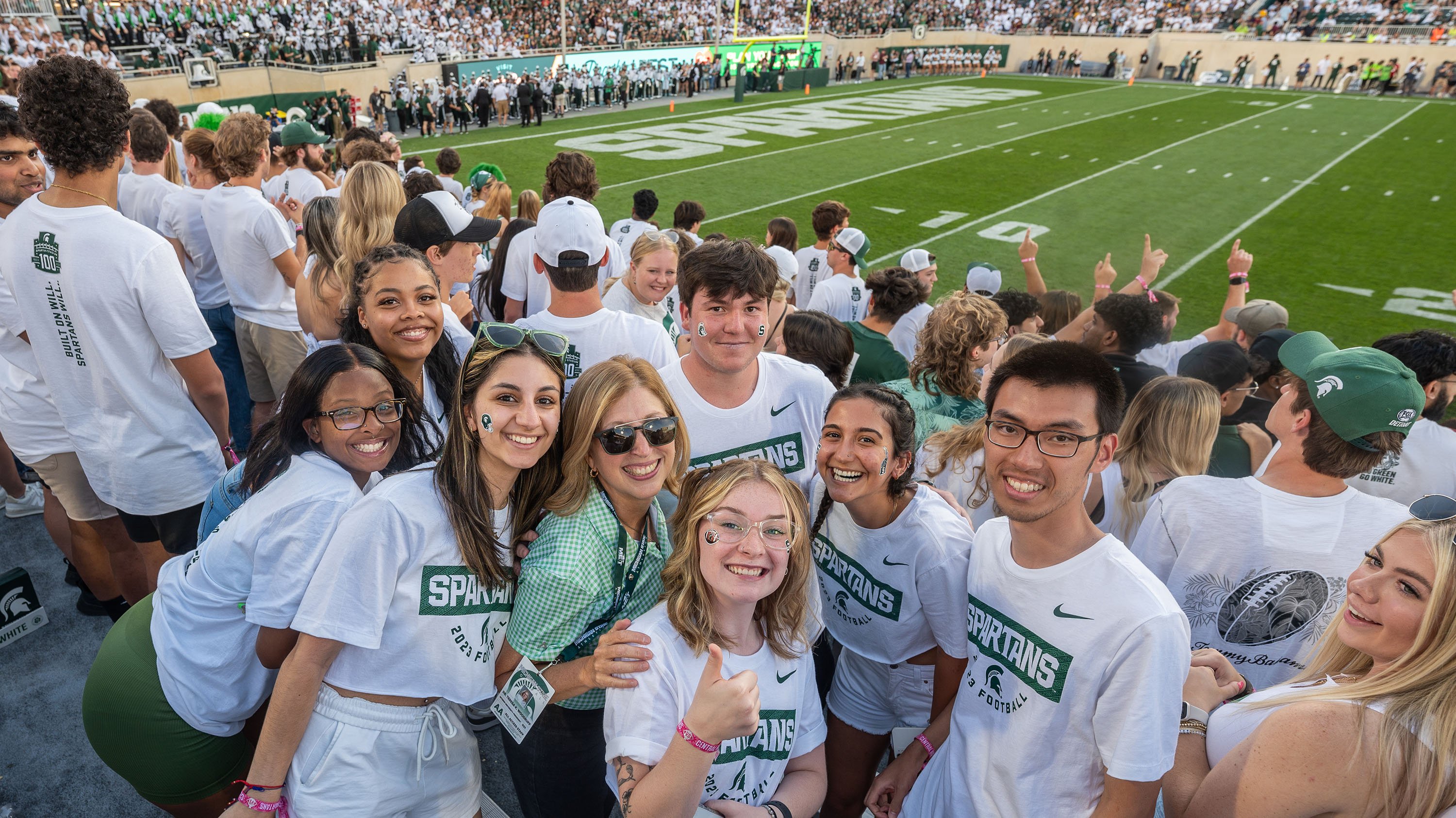 Interim President Woodruff in student section at football game