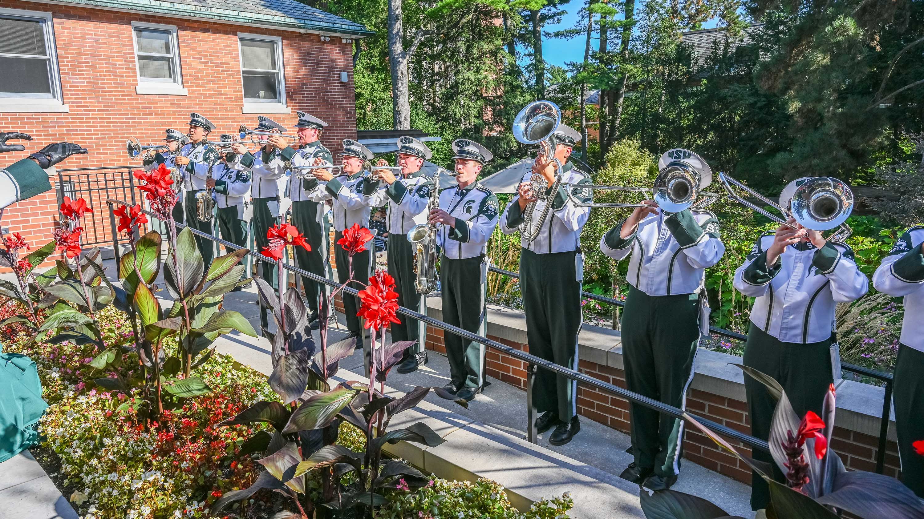 Marching band playing in front of Cowles House