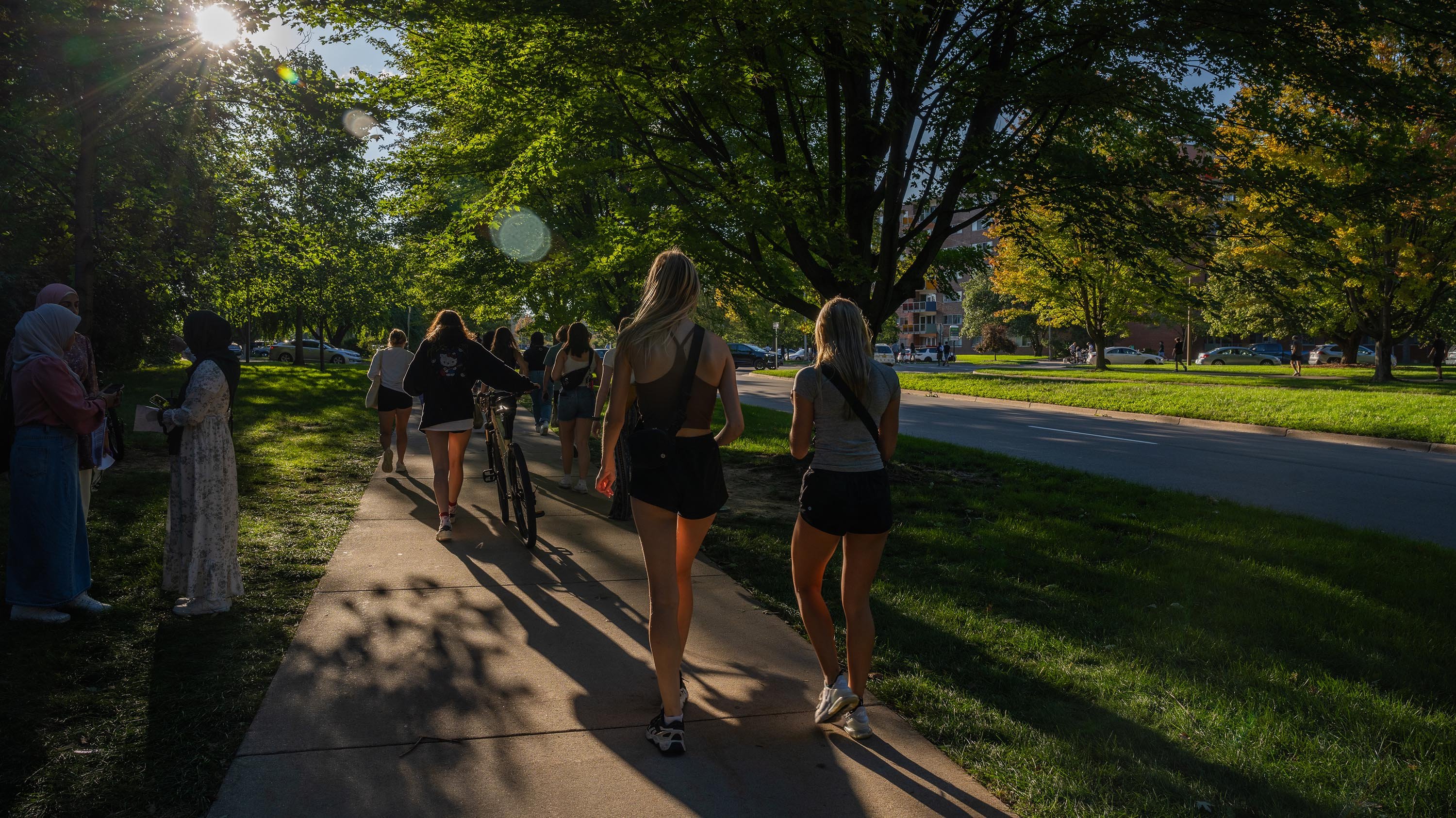 Students walking home from Sparticipation at sunset