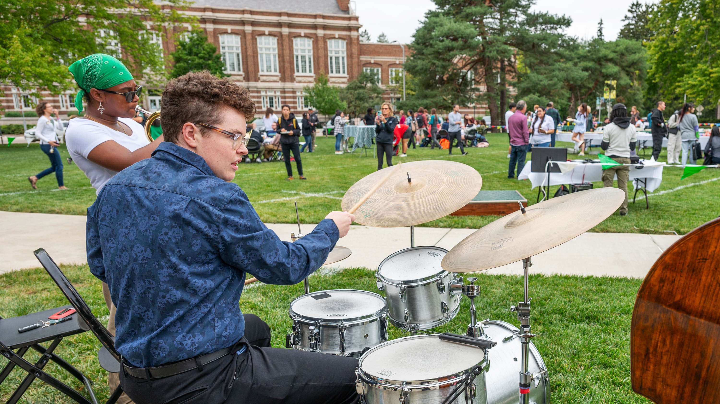 Students playing instruments outside the College of Music