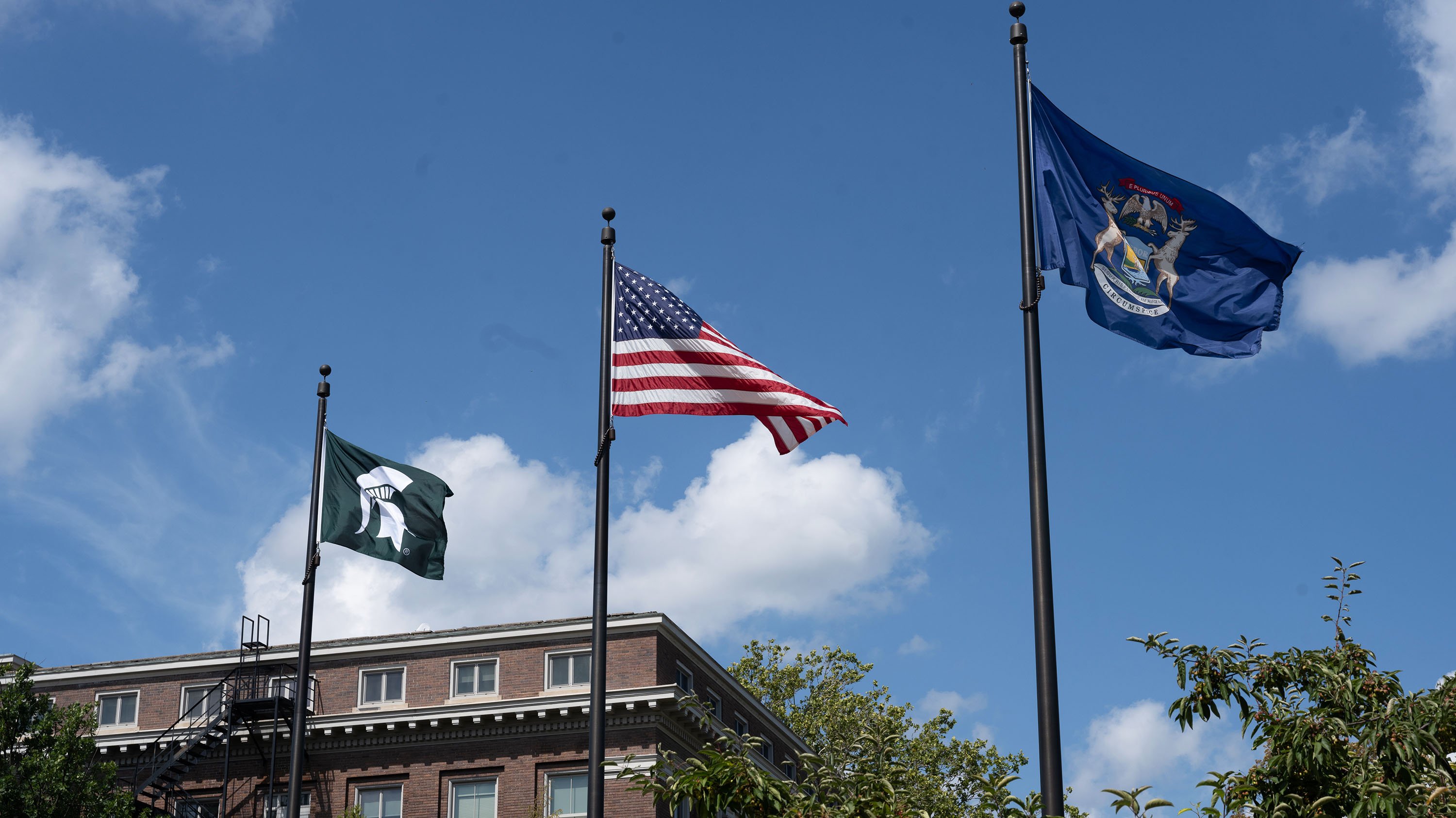 Spartan, American, and Michigan flags