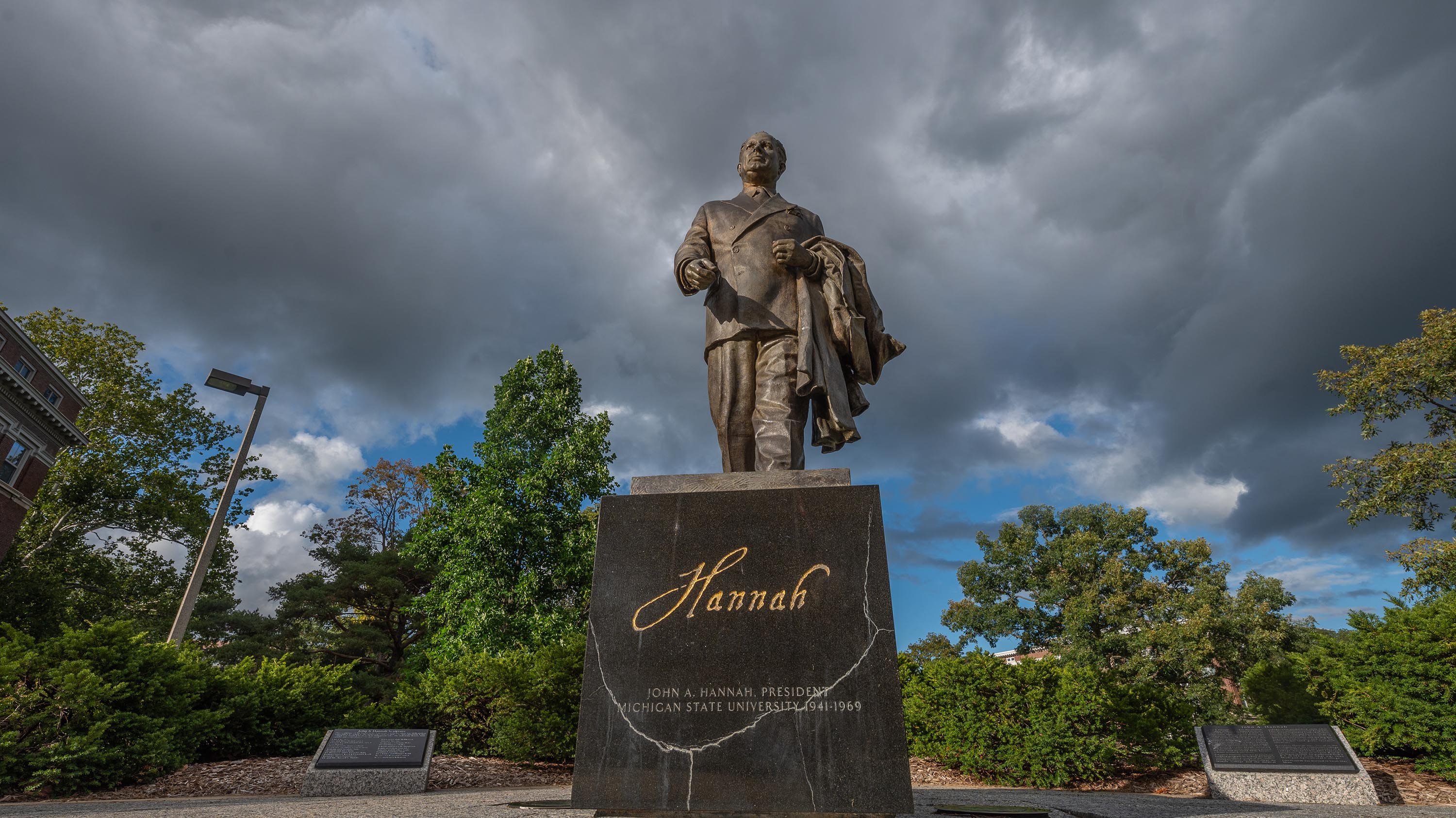 Dark clouds behind statue of John Hannah