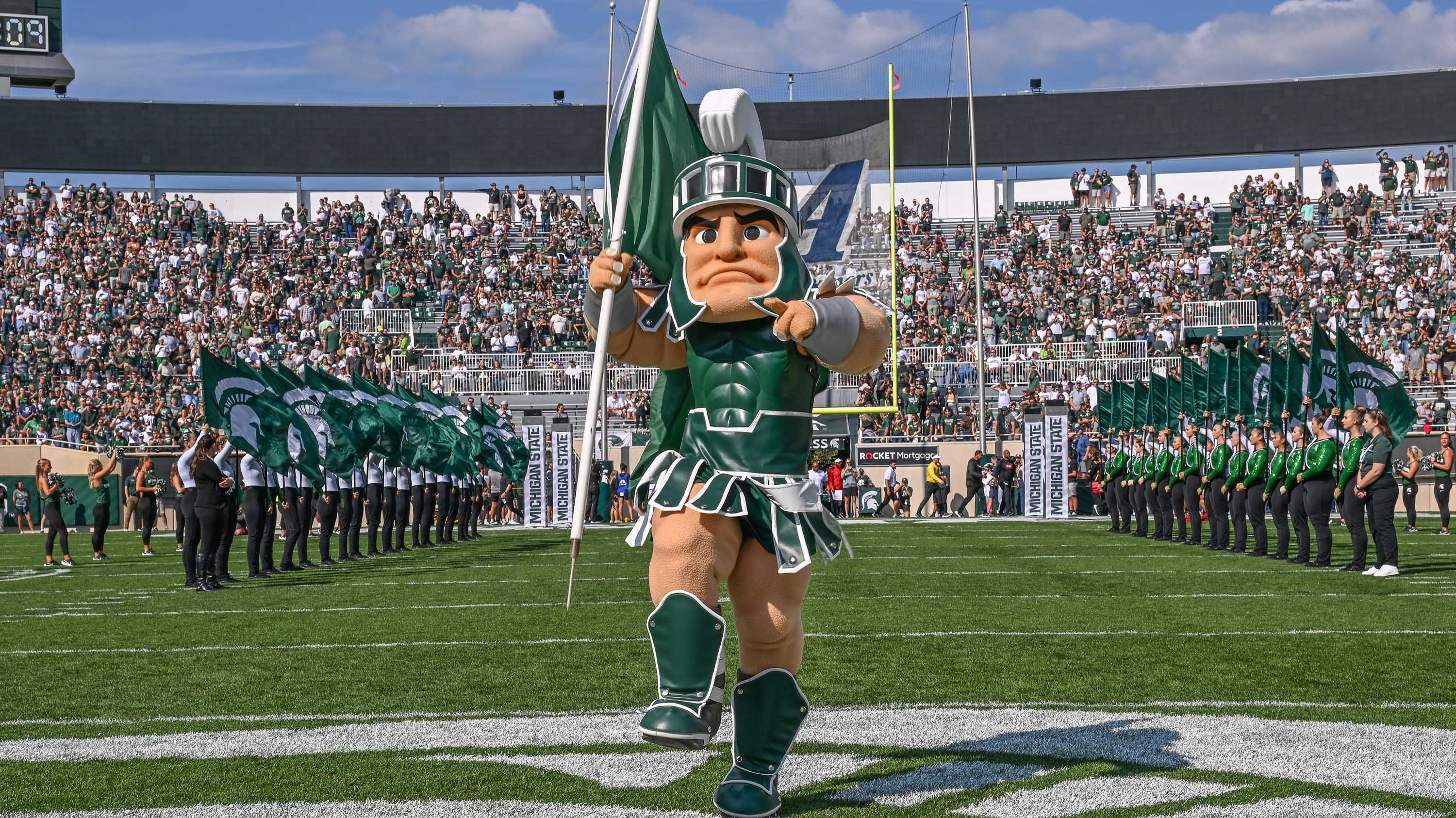 Sparty running onto field during homecoming game