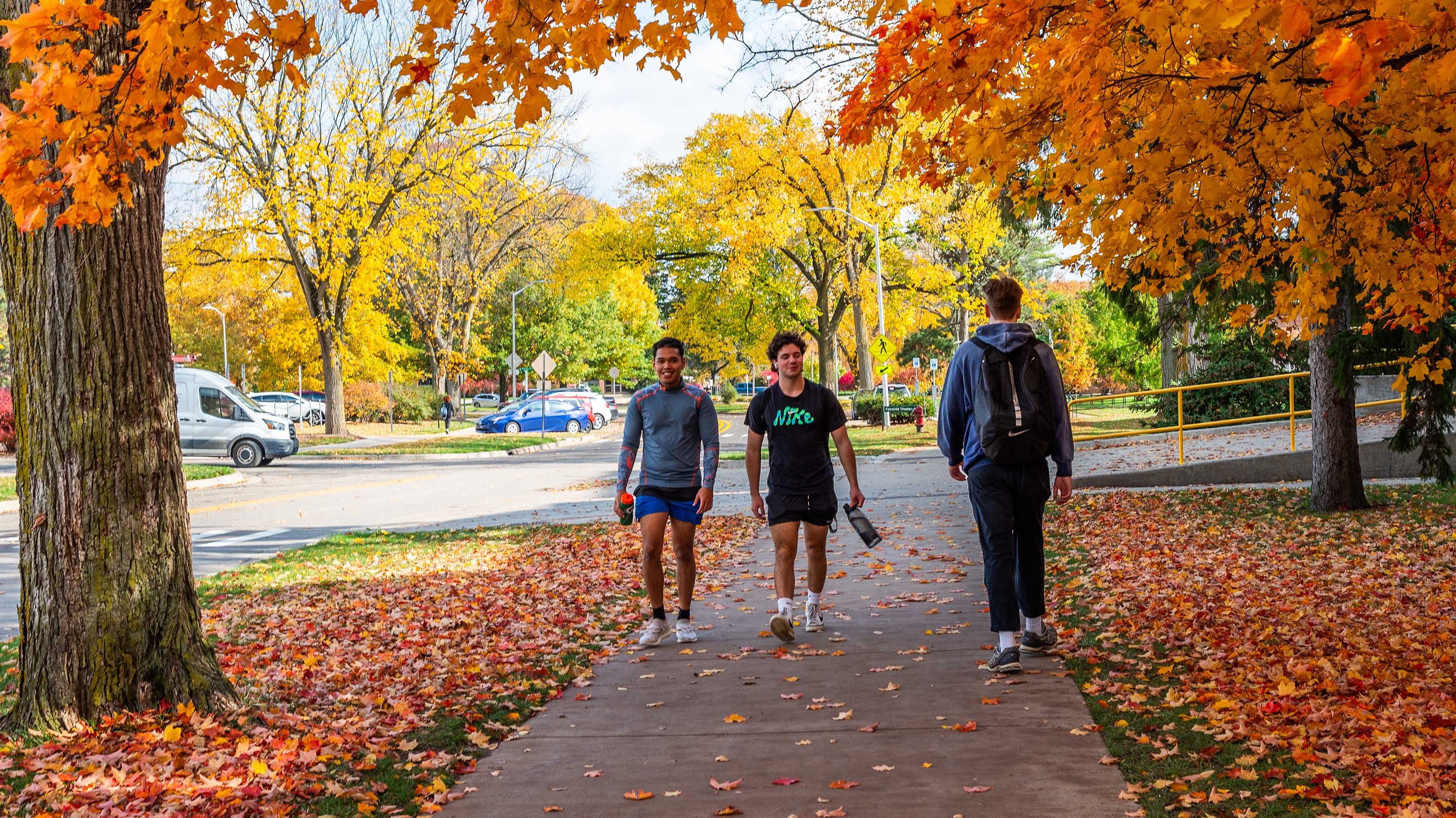 Students walking on campus in fall