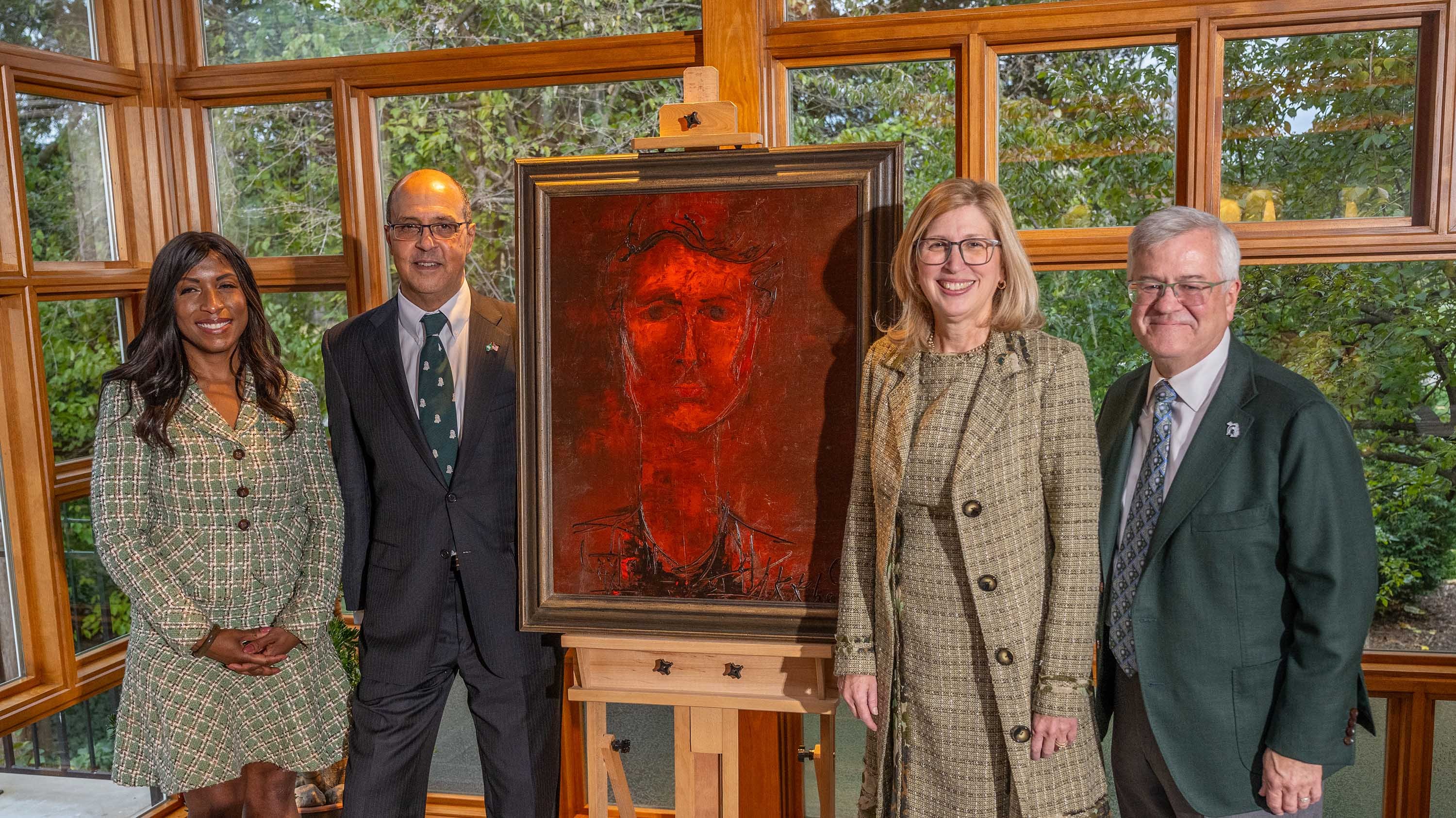 Bruce Wharton, Theresa Woodruff standing with portrait of Dolores Wharton