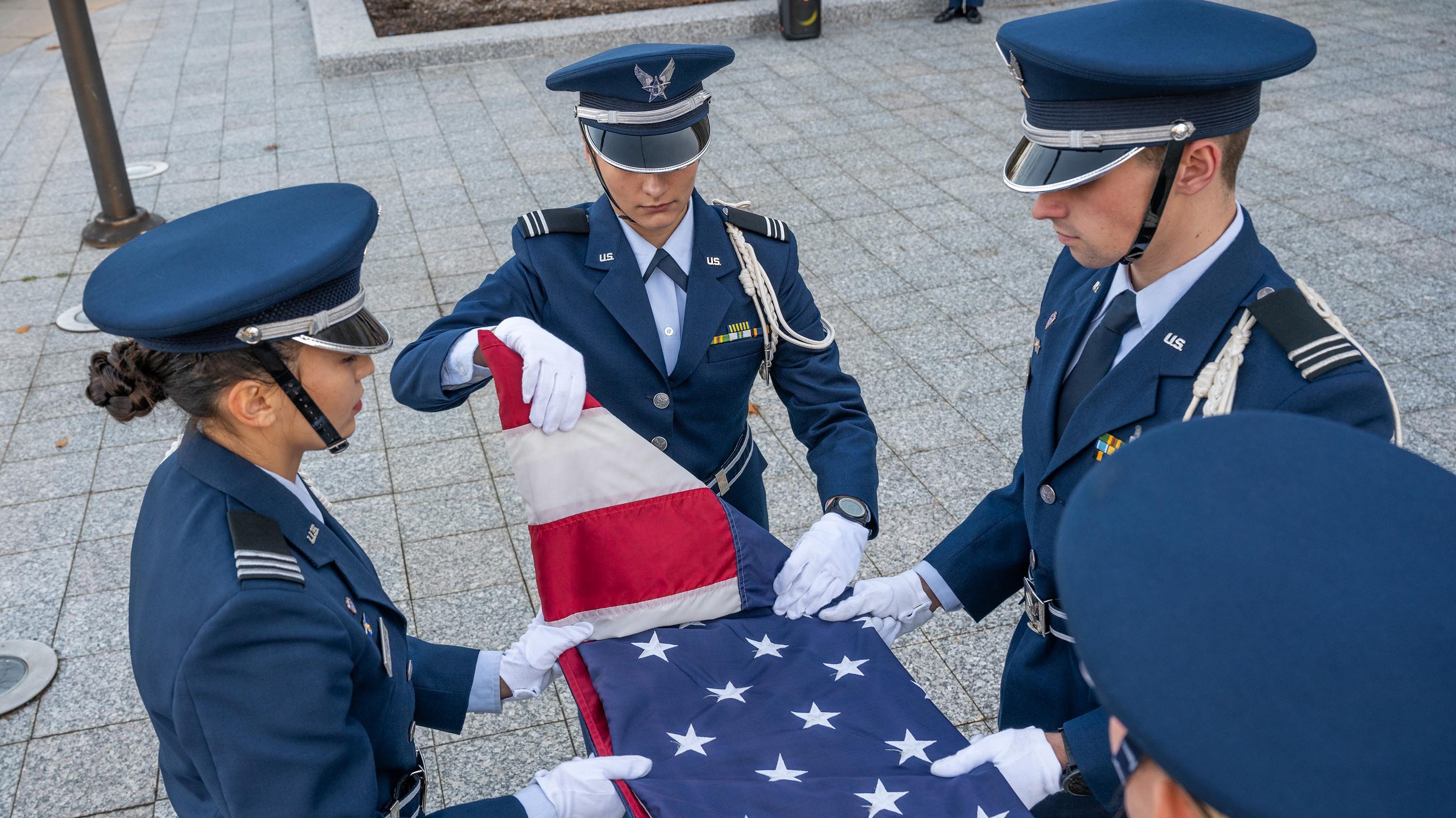 Air Force ROTC members folding flag after ceremony
