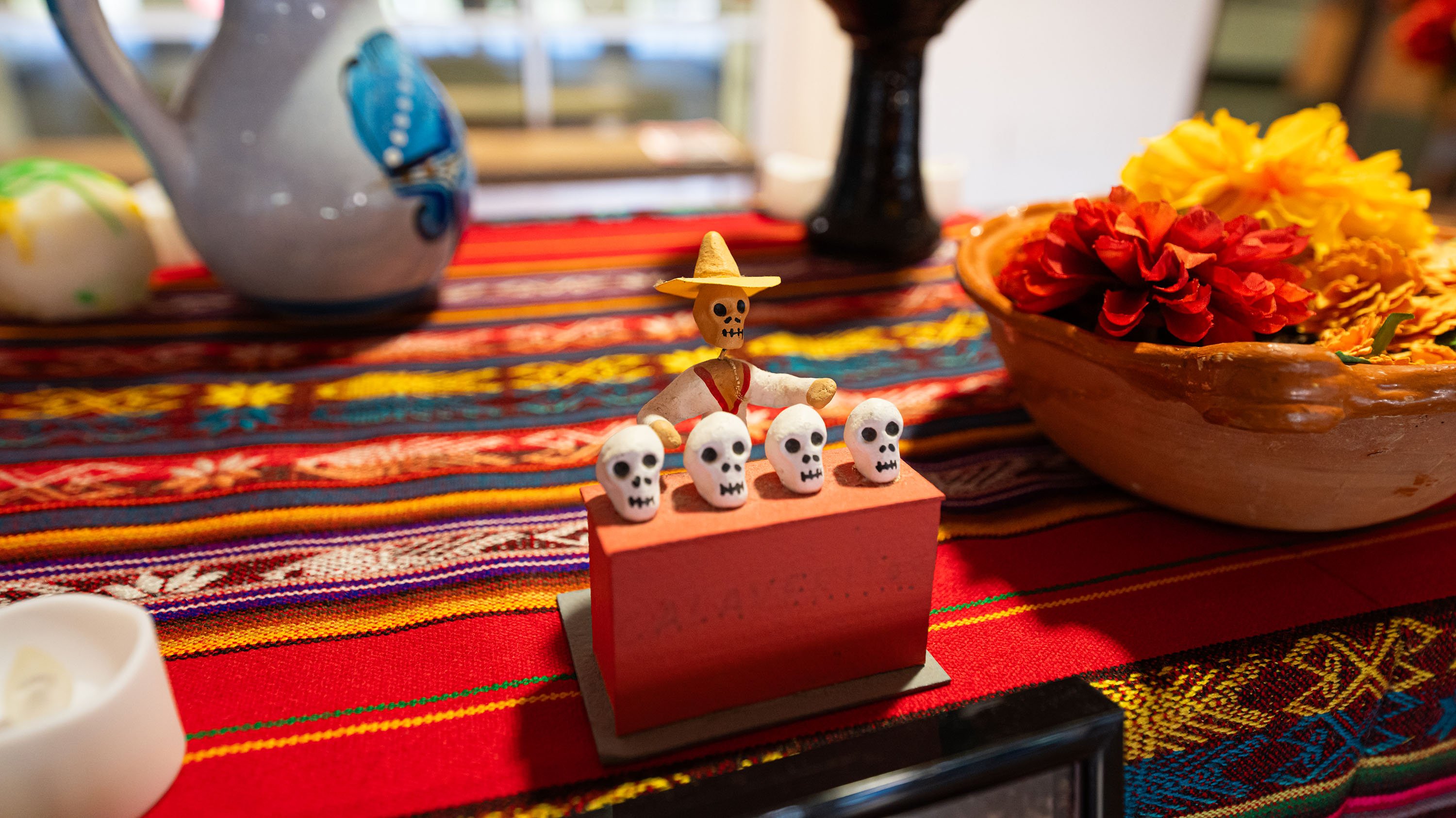 Small decorative skulls and skeleton figuring on an ofrenda in the RCAH LookOut gallery