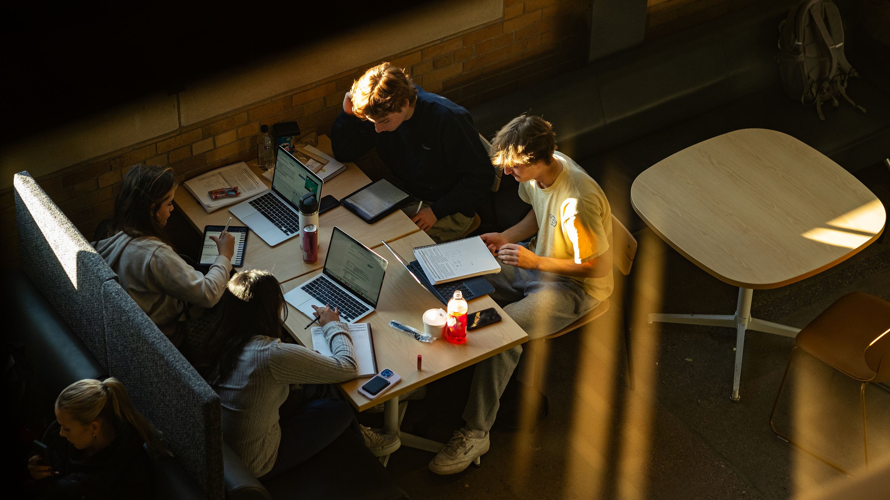 Four students studying at a table in the STEM building