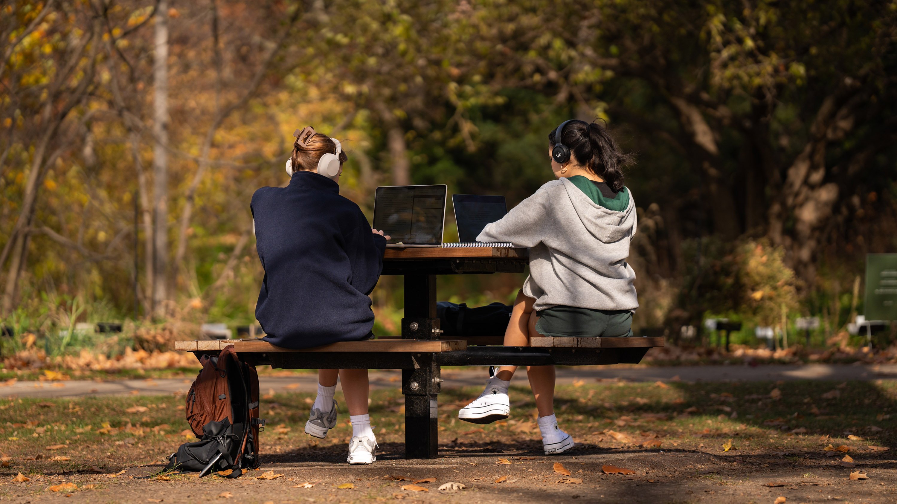 Two students studying at outdoor table