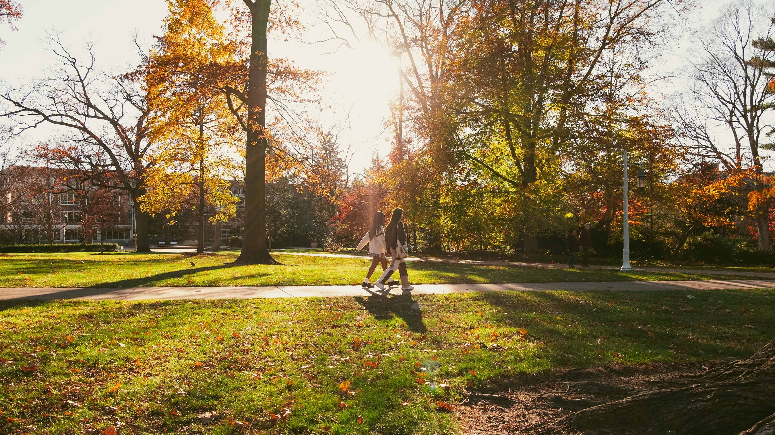 Two students walking on a campus path
