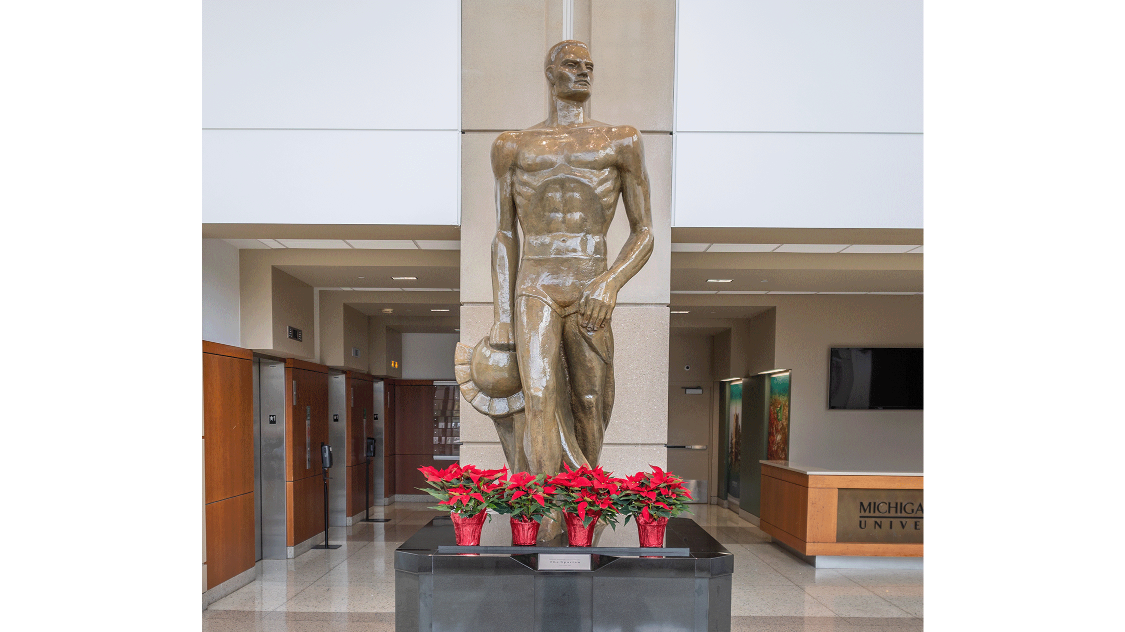 Original clay Spartan statue with poinsettias