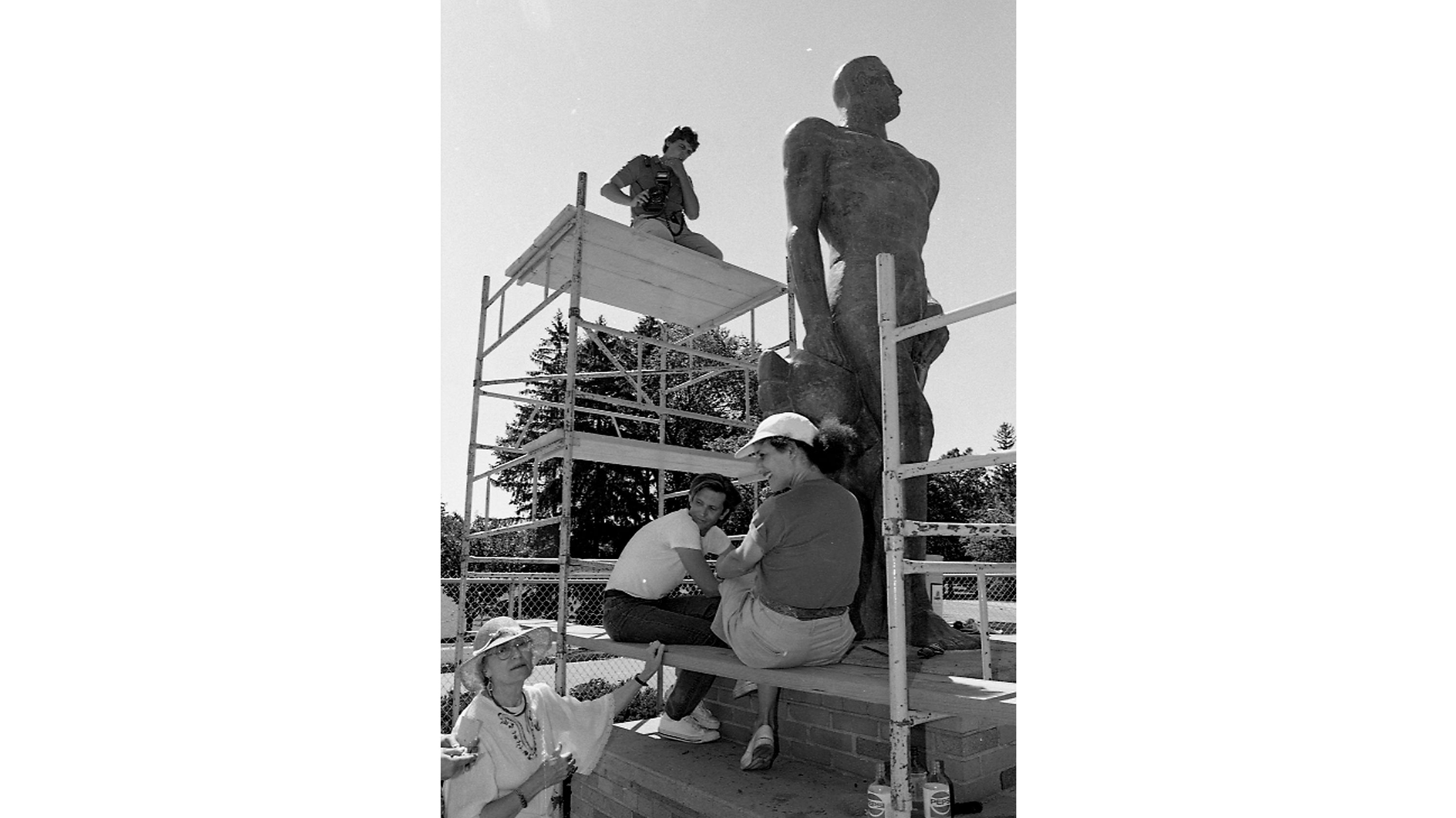 Scaffolding surrounding the Spartan statue, and workers helping to repair it.