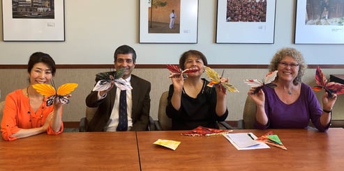 Mariko Kawaguchi and others making origami butterflies
