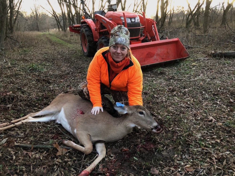 Sonja Christensen putting a radio tracker on a deer.