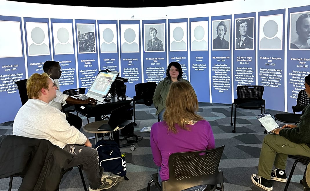 The Digital Humanities Seminar class works on designing the “Hidden Heroes: Women of the War” exhibit in the 360 Degree Visualization Room at the MSU Main Library.