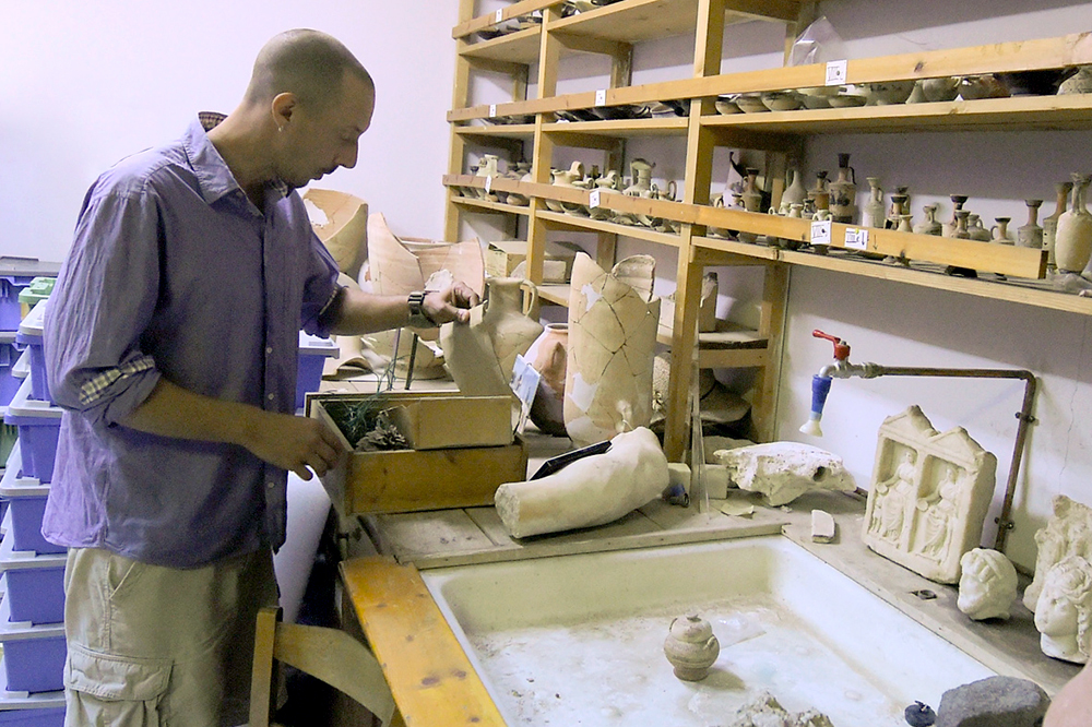 Jon Frey working with some of the artifacts in the collection at the MSU Excavations at Isthmia.