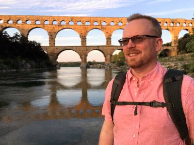 Jay Zarnetske in front of the Pont de Gard in France