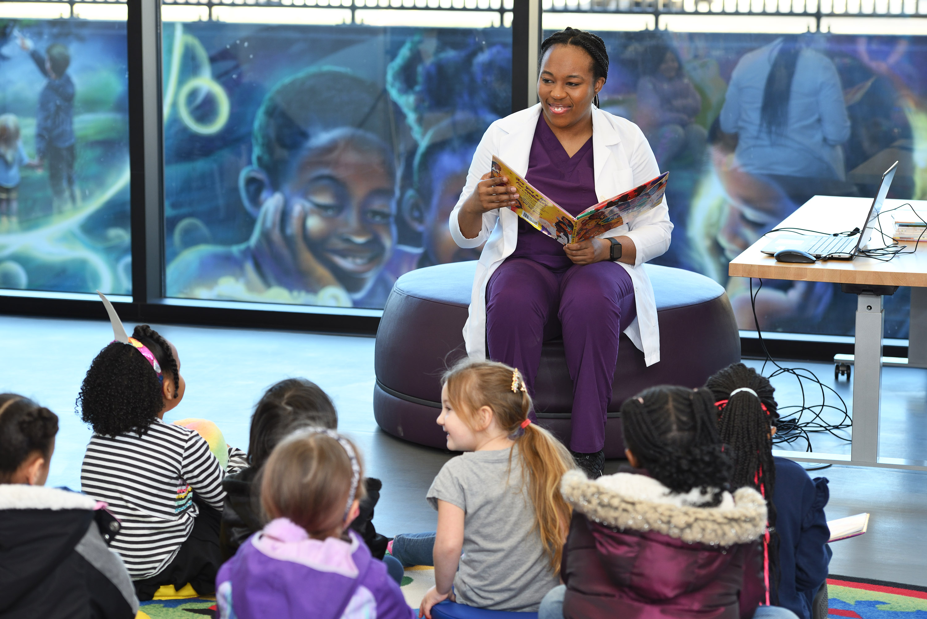 Uyeh reading book to group of children