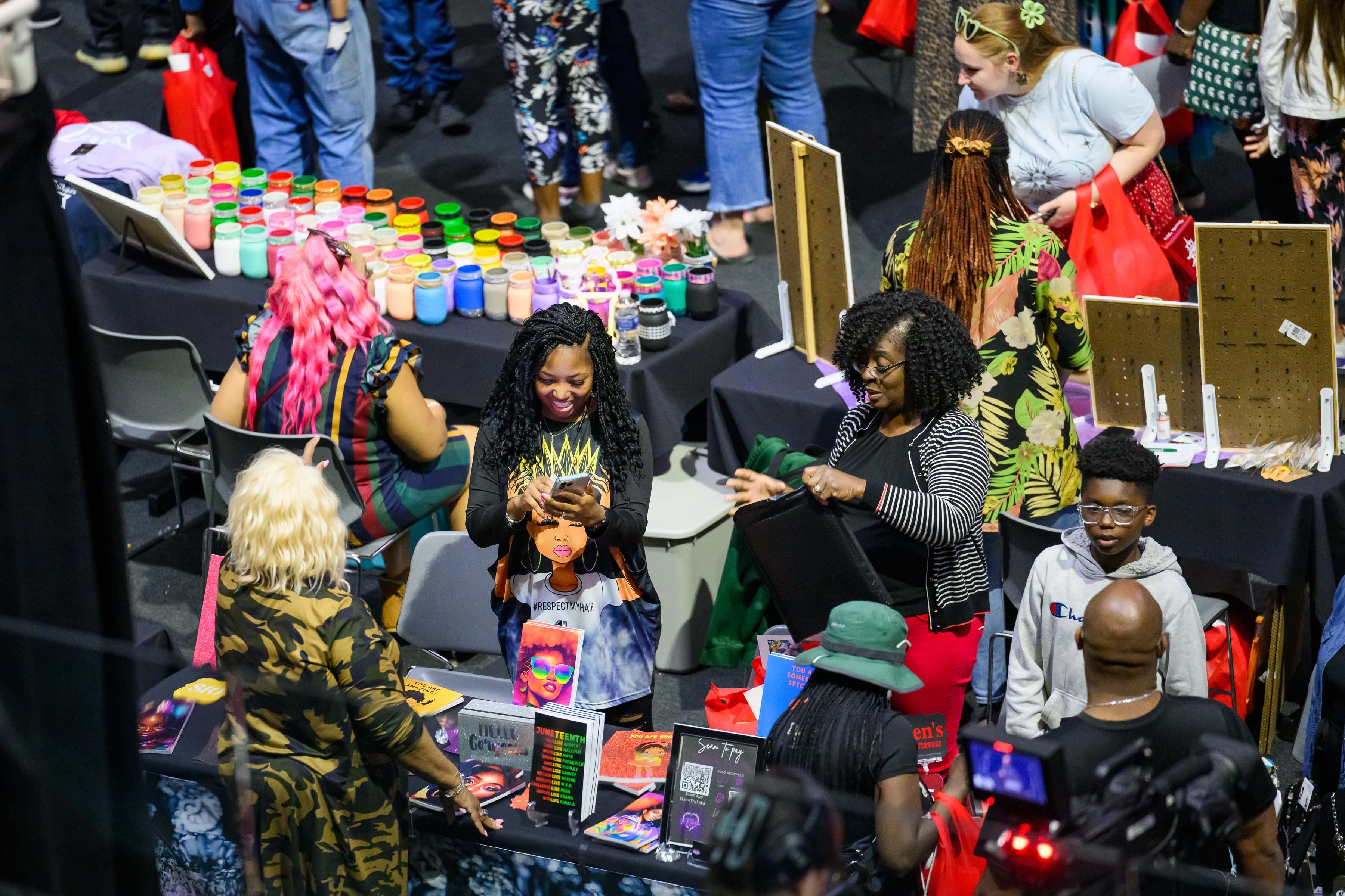 Participants visit the Black Wall Street Vendor Fair at the Juneteenth Celebration at the Breslin Center.