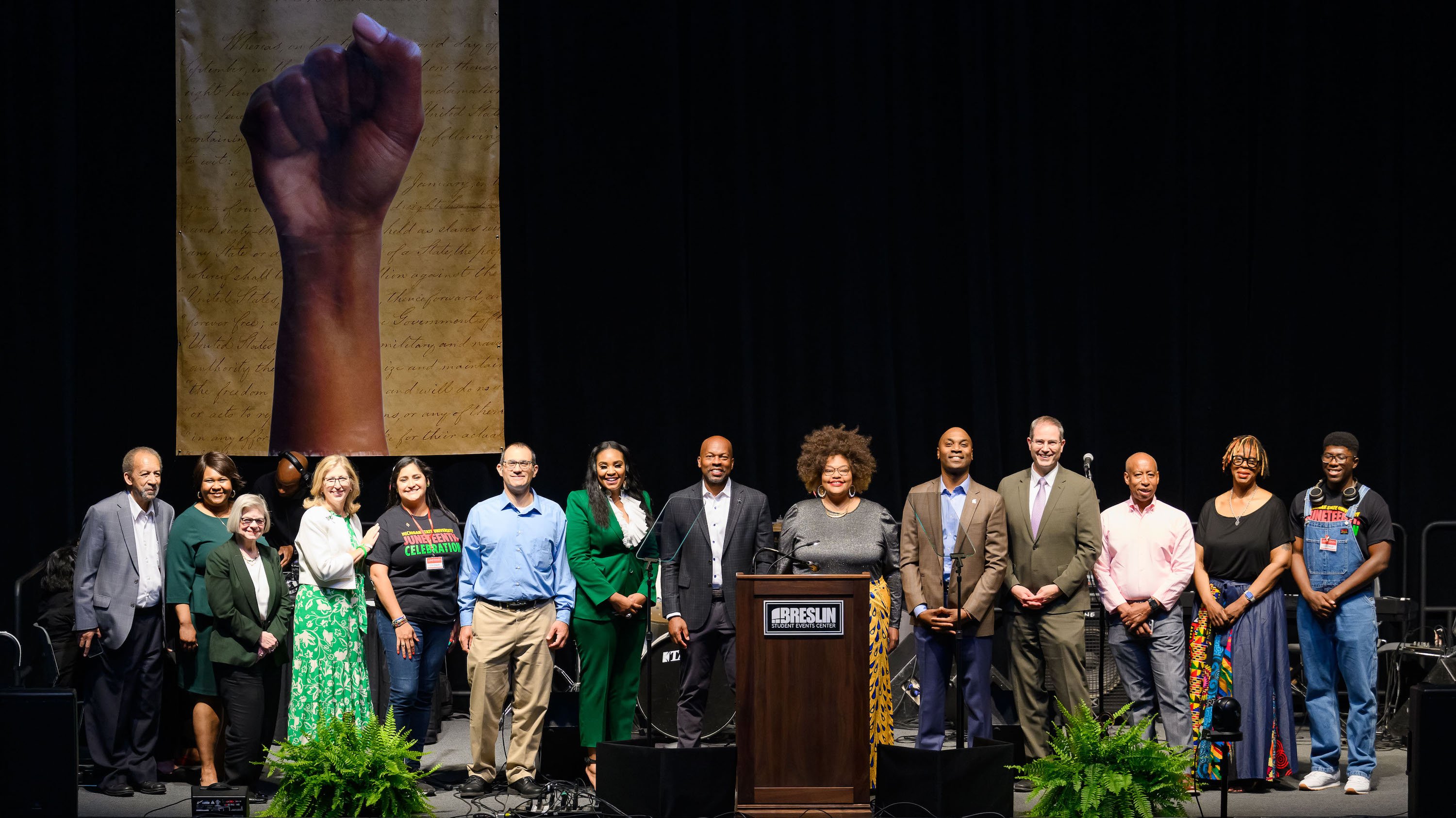 Senior leaders, performers and Juneteenth Planning Committee co-chairs join on stage for a group photo at the MSU Juneteenth Celebration