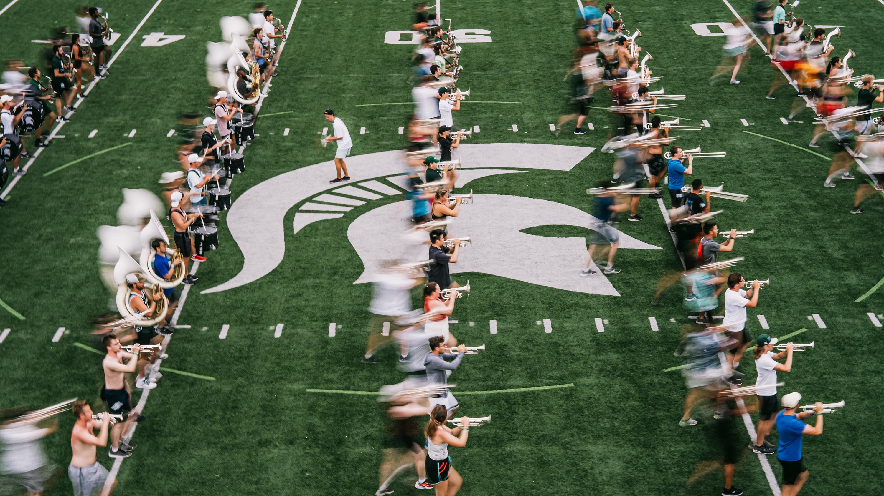 Image with motion-blur of band marching on field