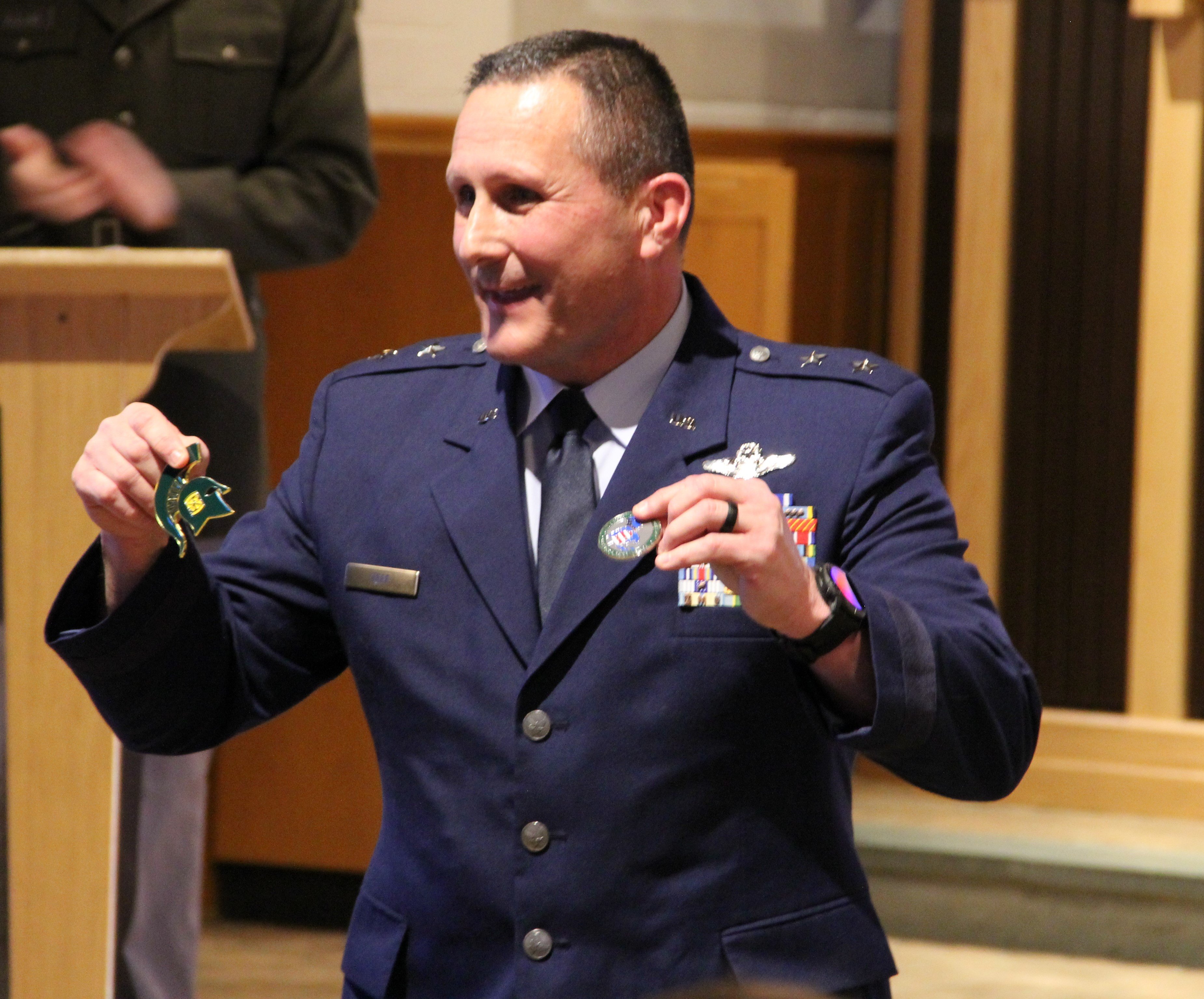 Maj. Gen. Bryan Teff, assistant adjutant general of the Michigan Air National Guard, the keynote speaker during the Michigan State University U.S. Air Force and U.S. Army ROTC Veterans Day ceremony on Thursday, Nov. 9, 2023 at the MSU Alumni Memorial Chapel, is presented challenge coins from the Air Force and Army ROTC.