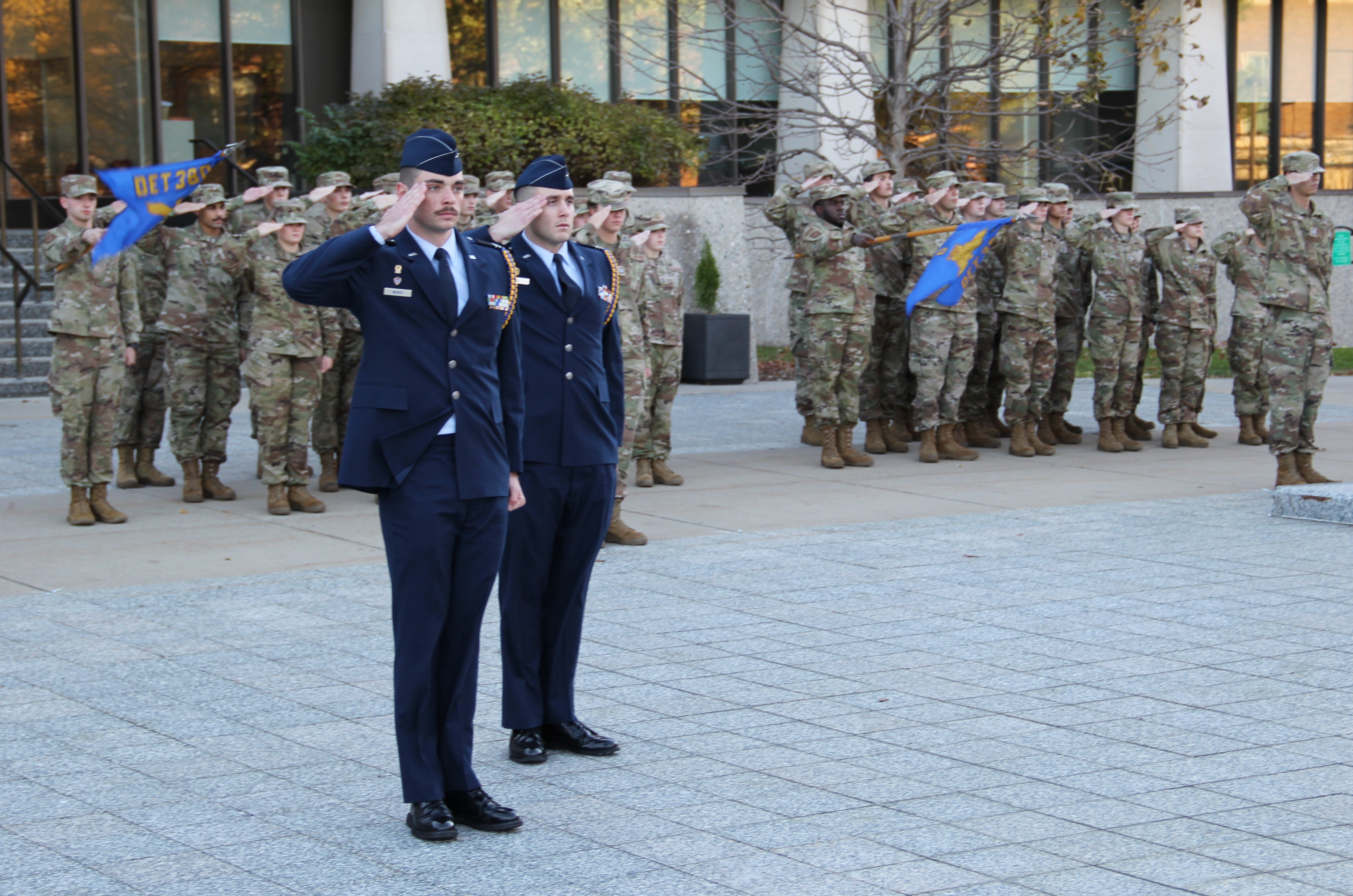 Members of the Michigan State University U.S. Air Force ROTC, front, and members of the MSU U.S. Army ROTC, back, salute in formation in front of the Hannah Administration Building as part of a Veterans Day ceremony on Thursday, Nov. 9, 2023.