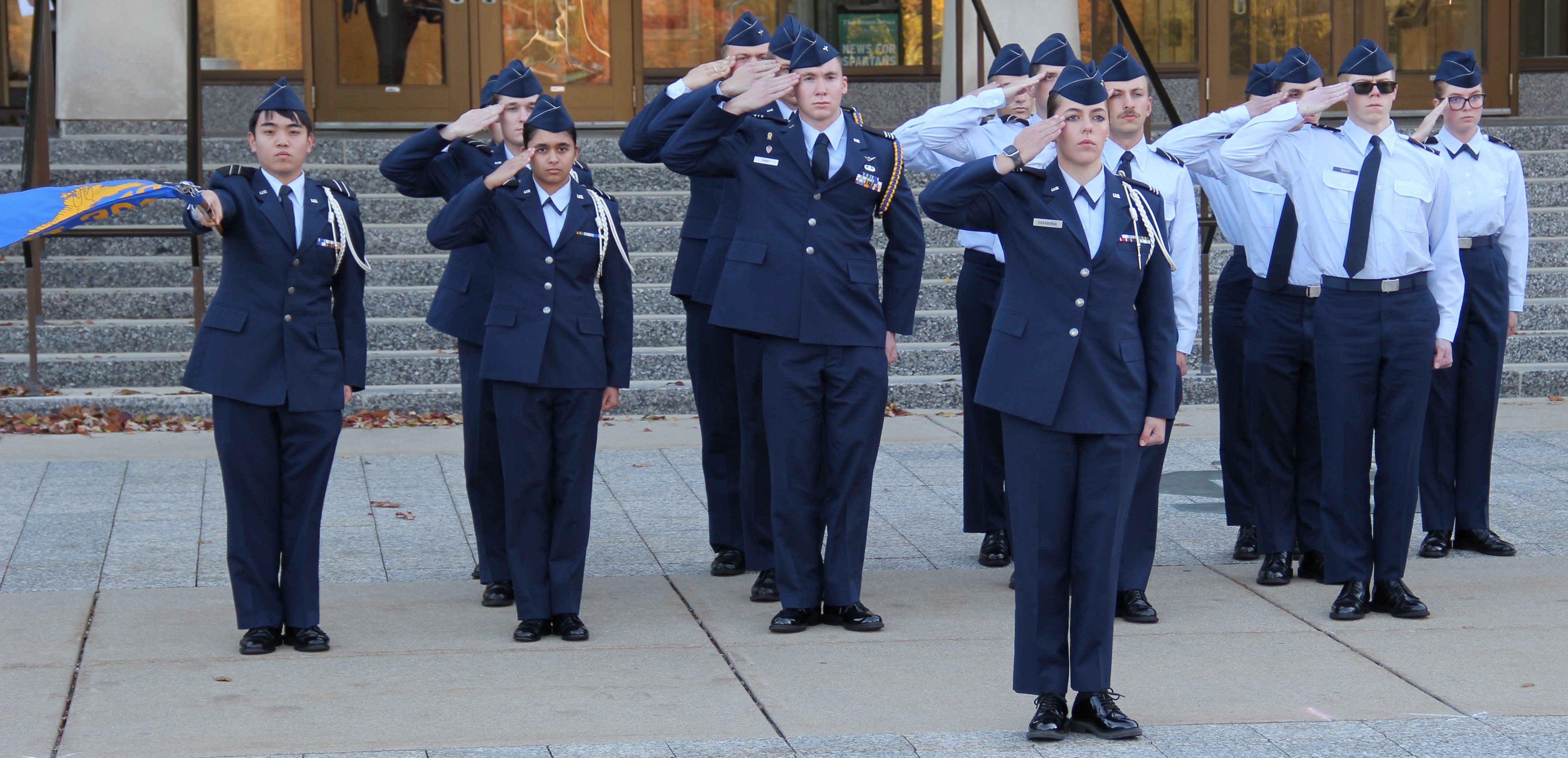 Members of the Michigan State University U.S. Air Force ROTC salute in formation in front of the Hannah Administration Building as part of a Veterans Day ceremony on Thursday, Nov. 9, 2023.