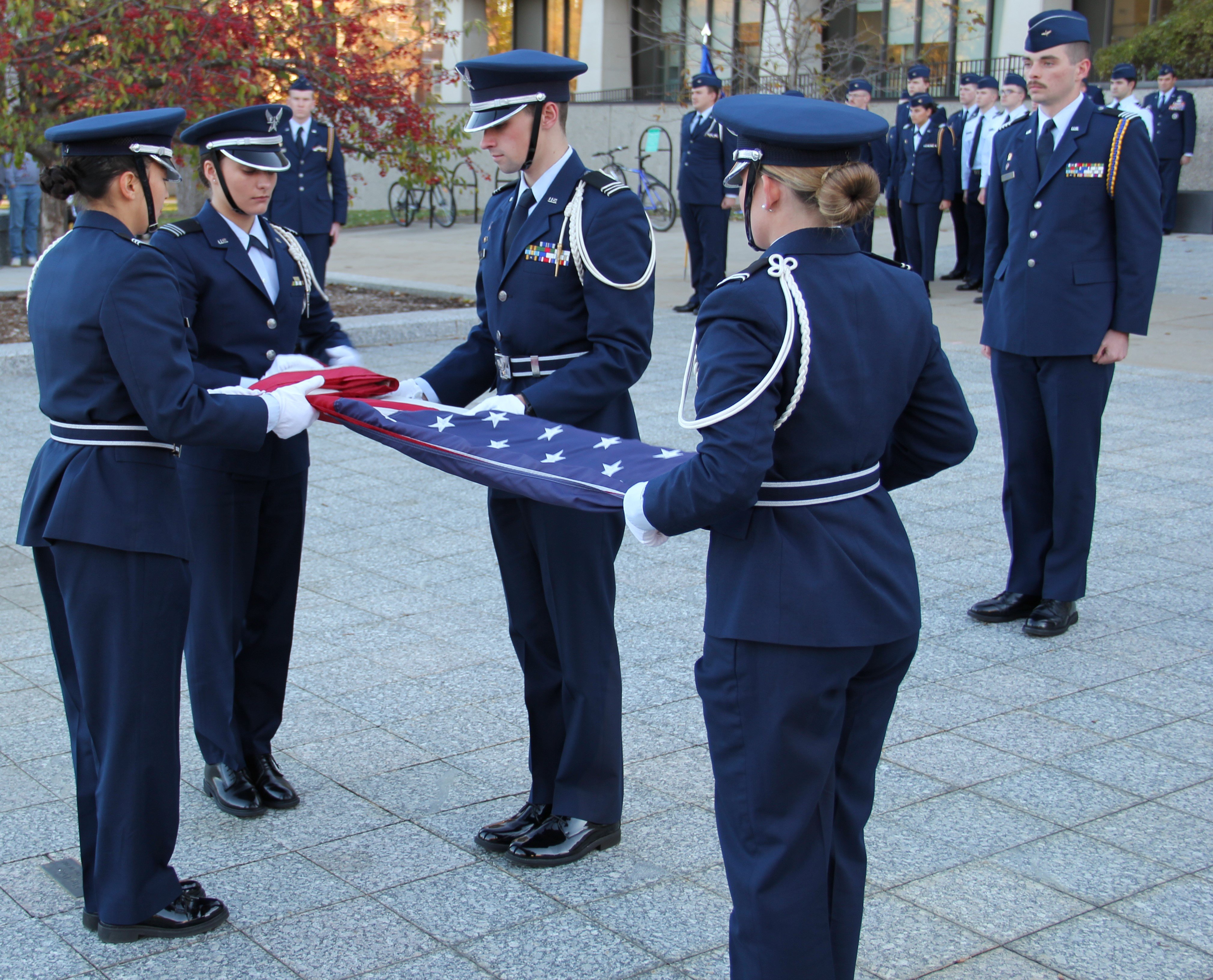 Members of the Michigan State University U.S. Air Force ROTC conduct a ceremonial flag folding in front of the Hannah Administration Building as part of a Veterans Day ceremony on Thursday, Nov. 9, 2023.