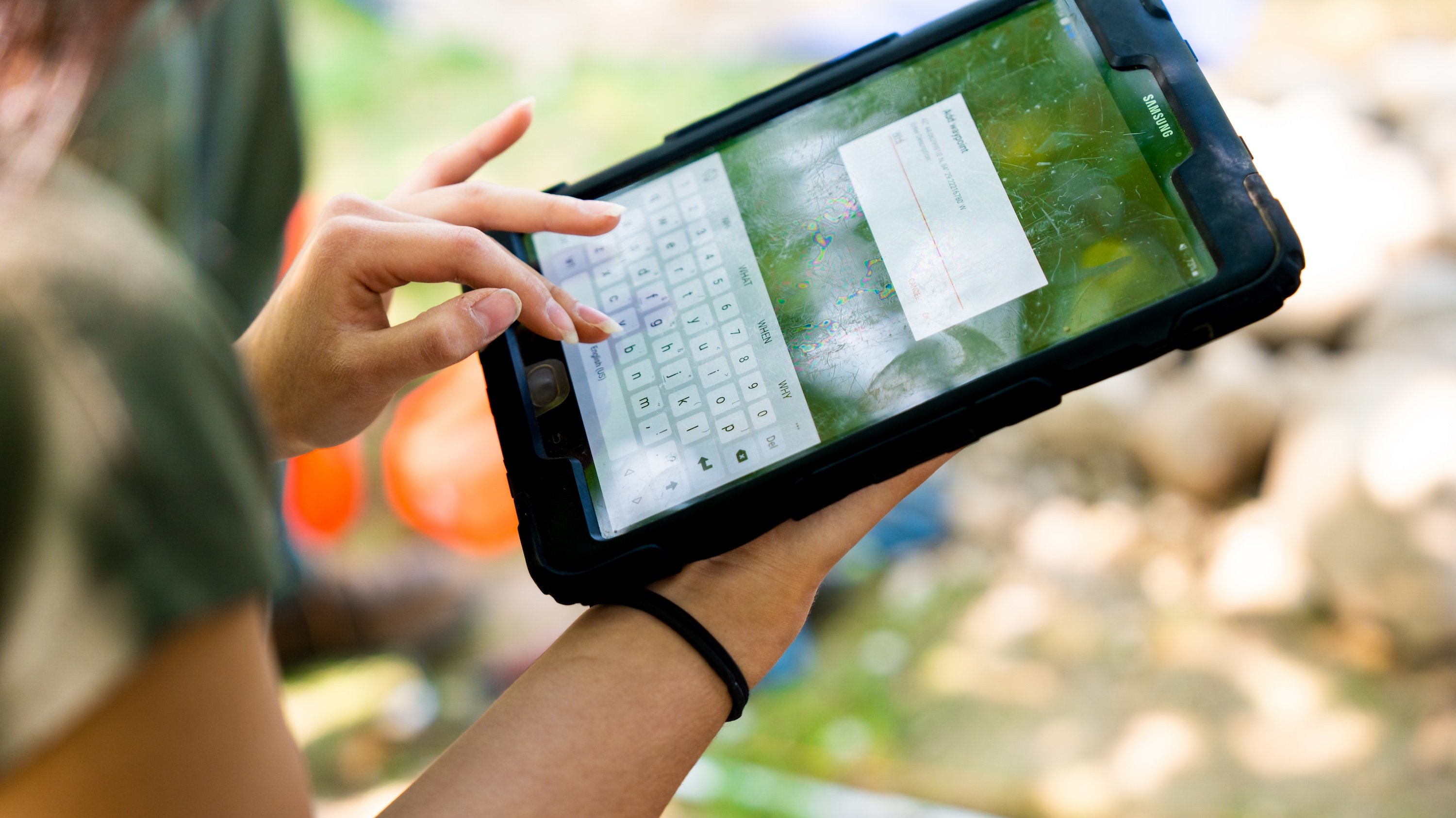 A person types on an iPad.