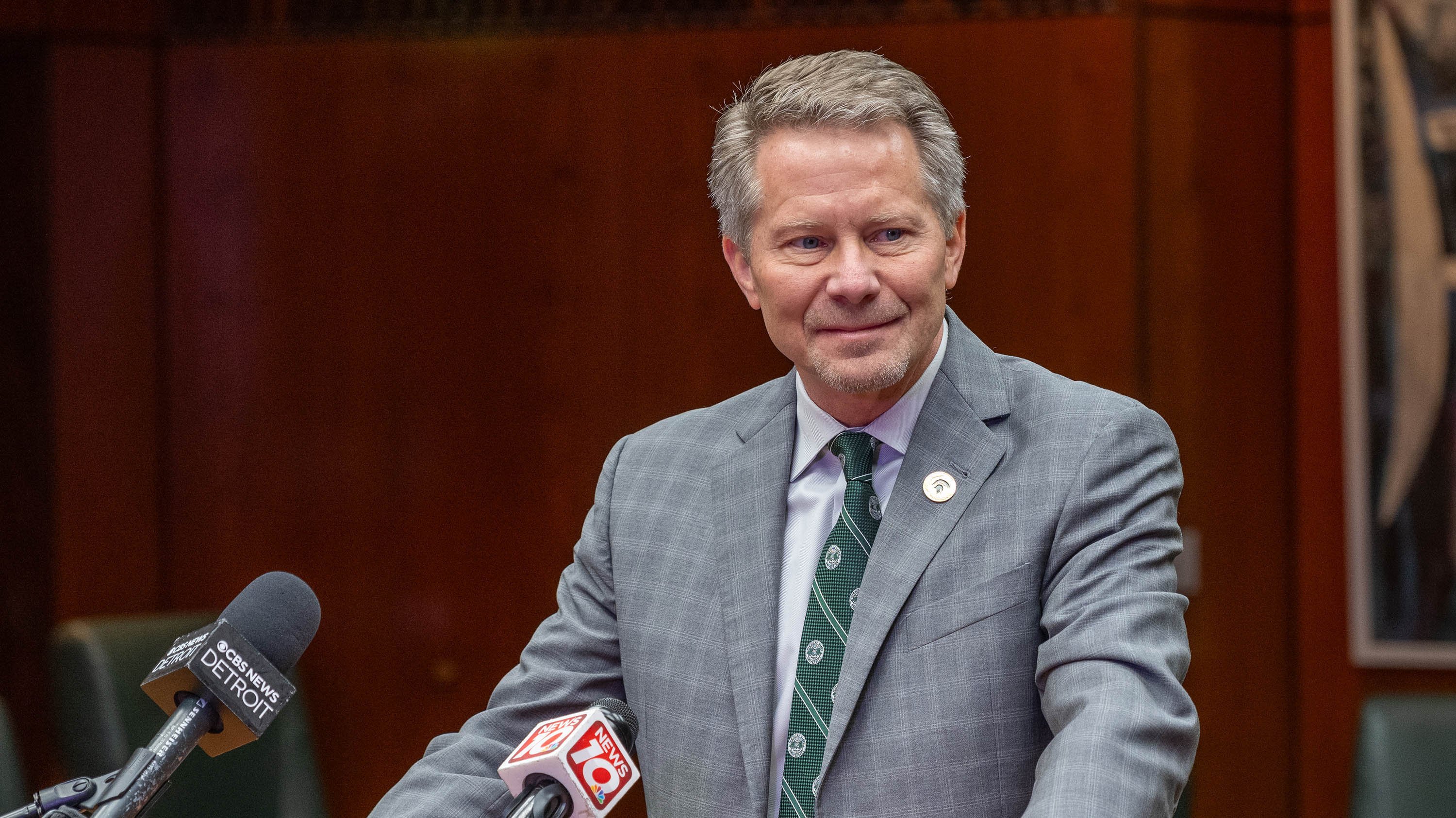 President-elect Kevin Guskiewicz at the mic during a media scrum.