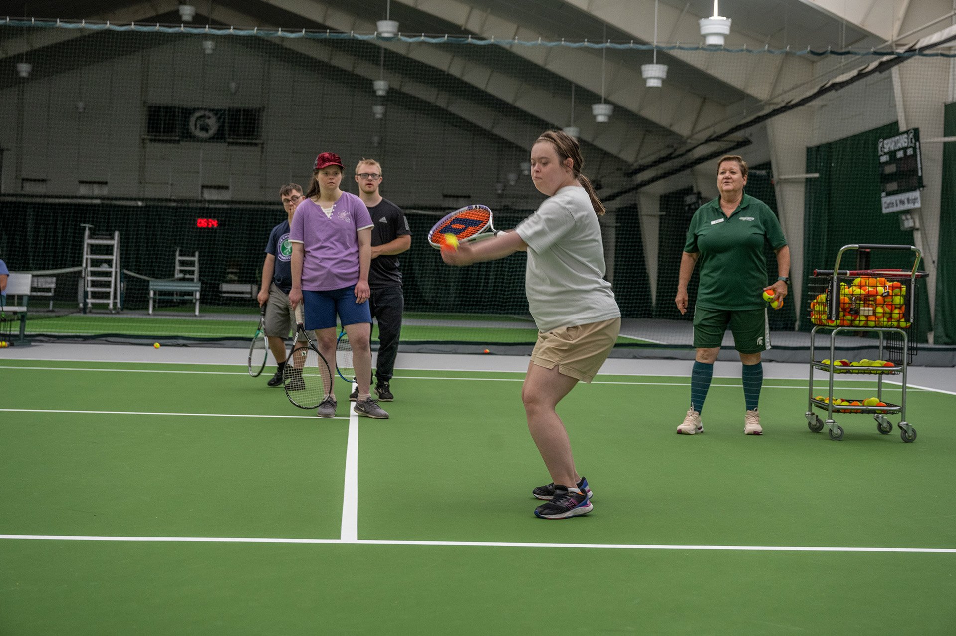 a participate is about to serve a tennis ball on the court