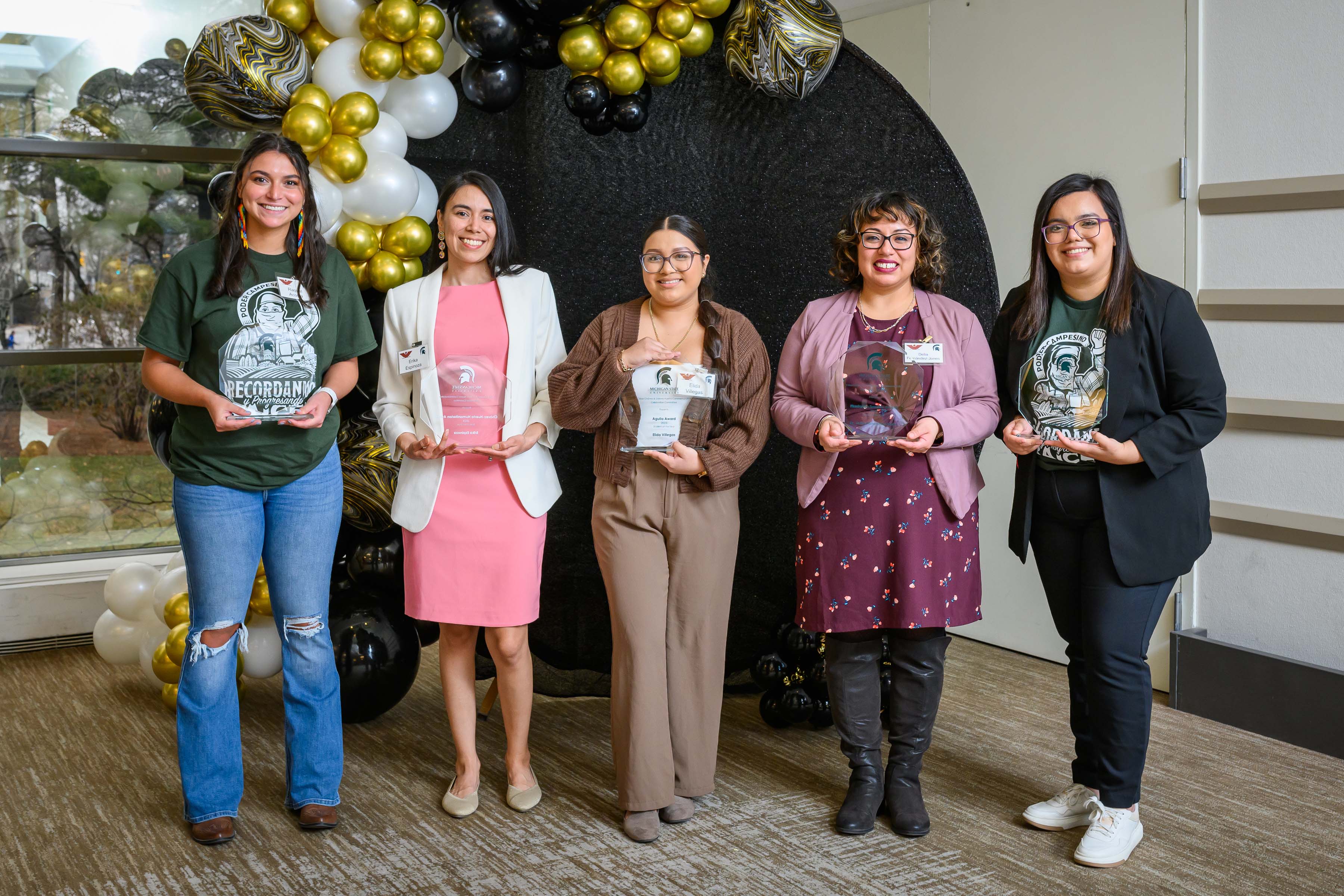 Awardees posing with plaques