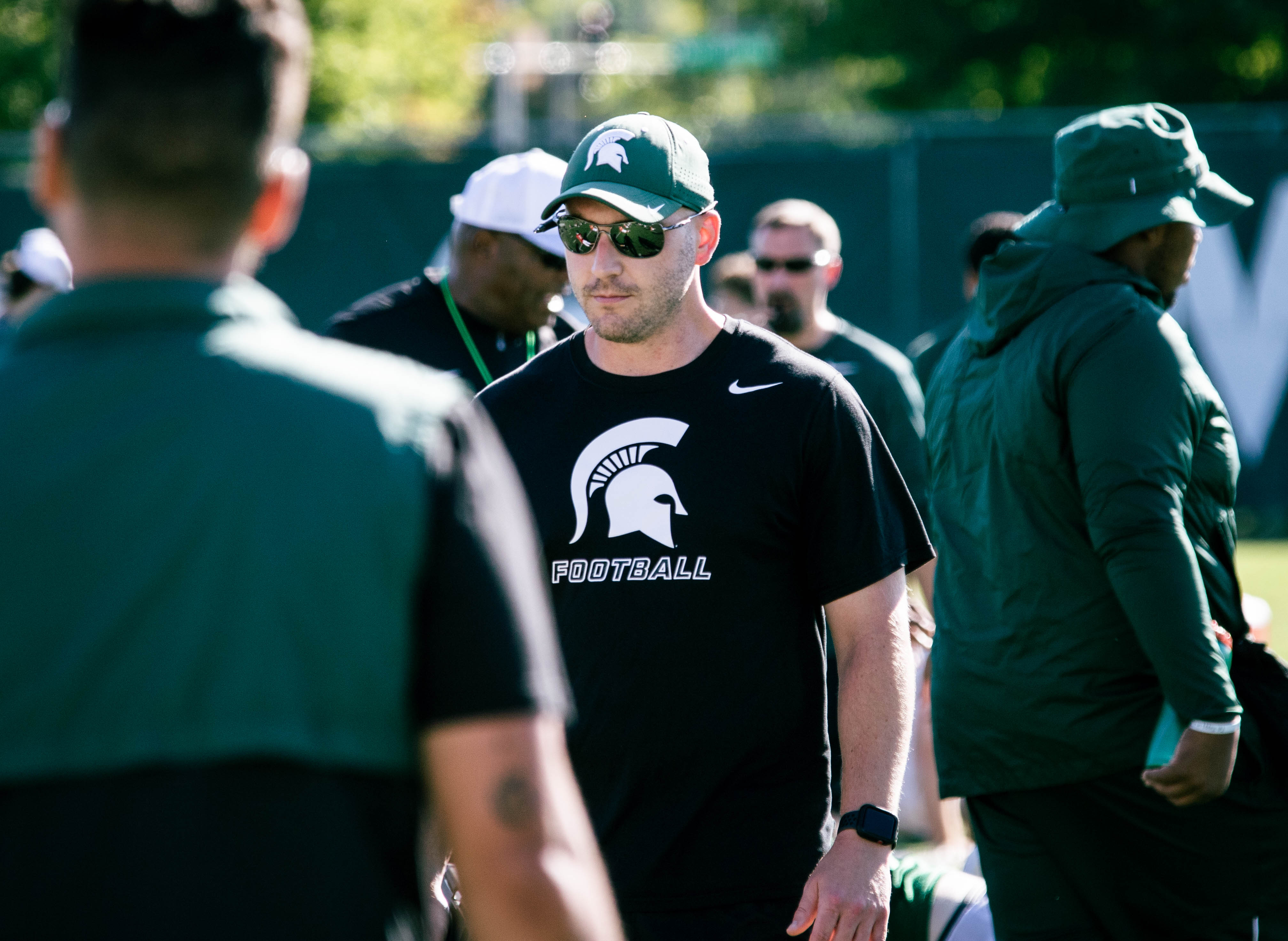 Bill Burghardt, wearing a Spartan hat, sunglasses and a black MSU football shirt