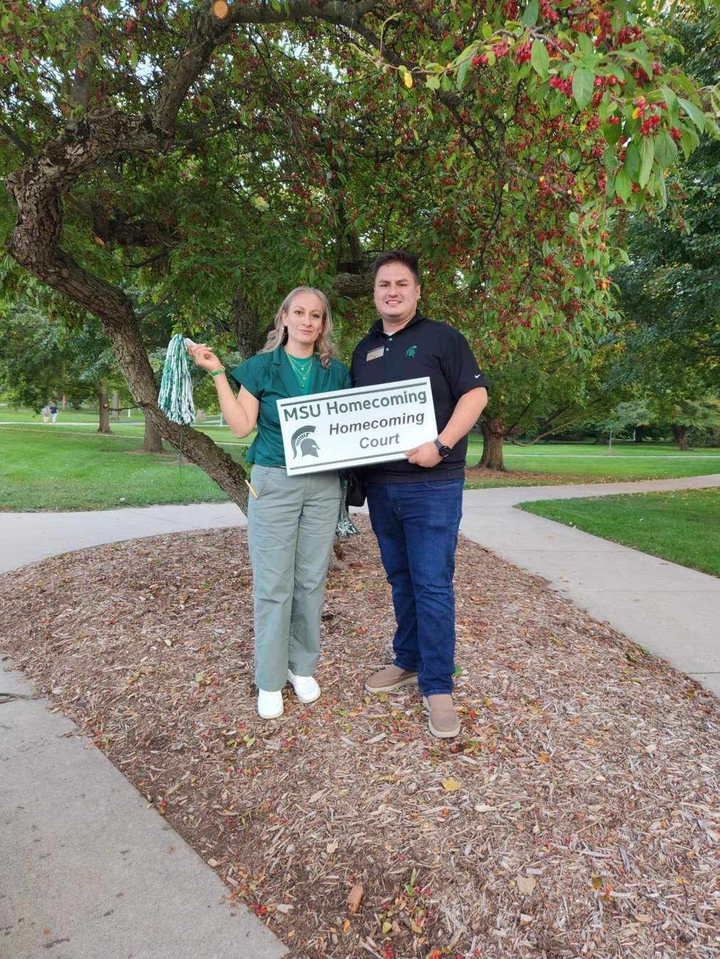 George holds homecoming sign with his mom