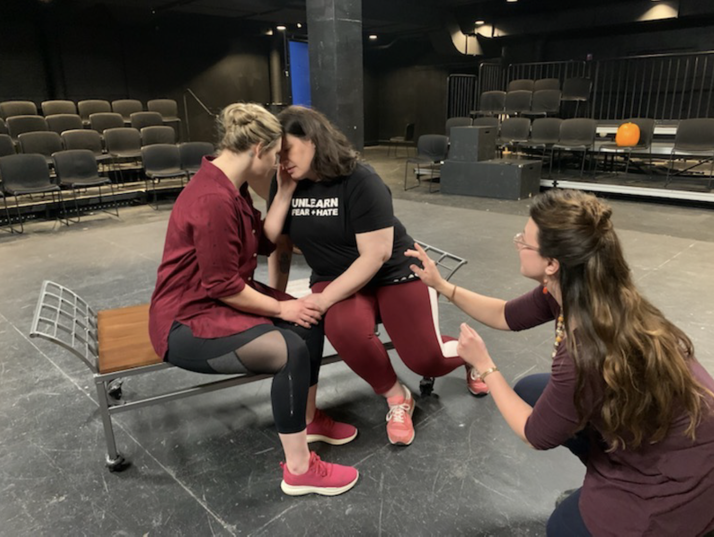Alexis Black directing a moment of staged intimacy during a rehearsal.