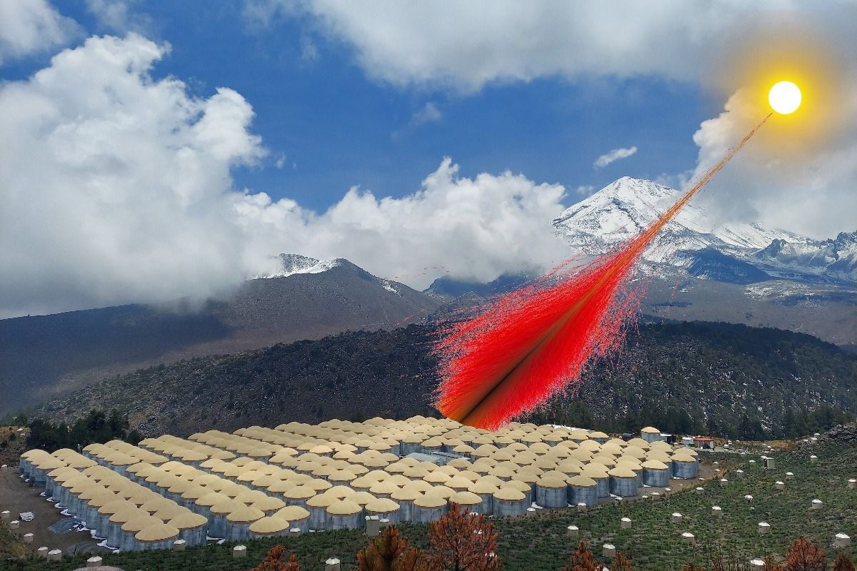 A composite image shows a photograph of the High-Altitude Water Cherenkov Observatory in Mexico. The observatory is a grid of 300 water tanks with steel walls and tan caps. A portion of these tanks are being struck by red lines, showing the trajectory of particles generated by high-energy gamma rays from the sun.