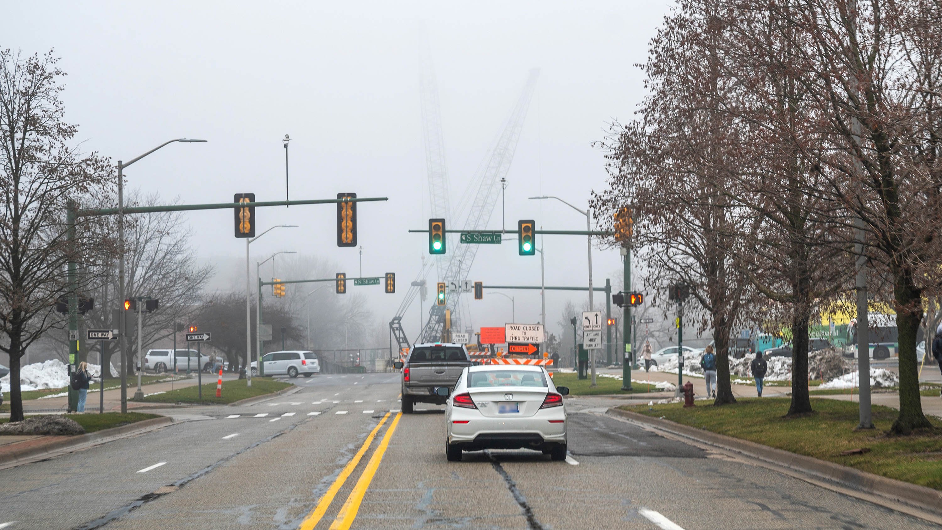Road with cranes in distance