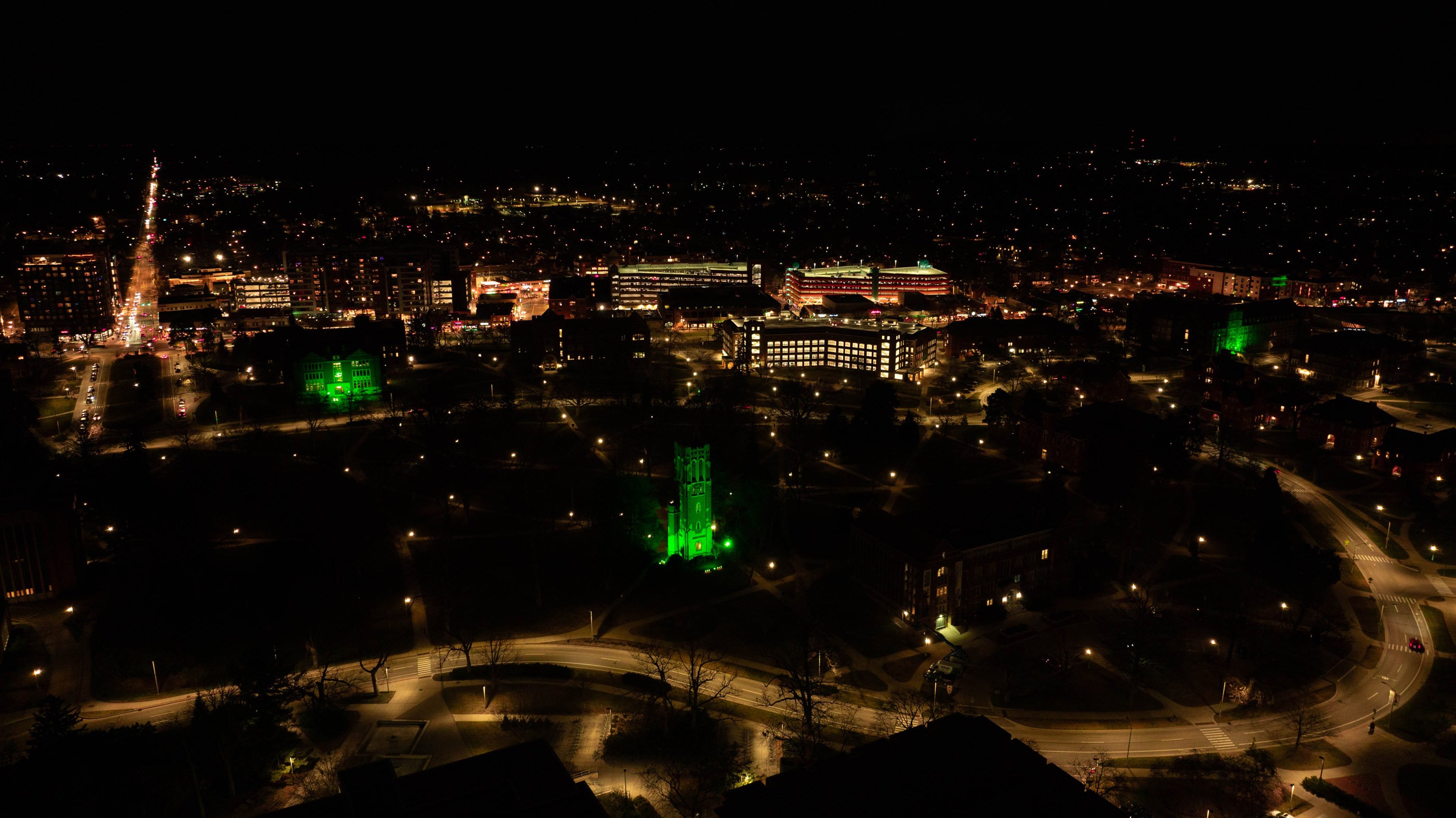 Overhead view of campus, showing Beaumont Tower, Berkey Hall and the MSU Union glowing green