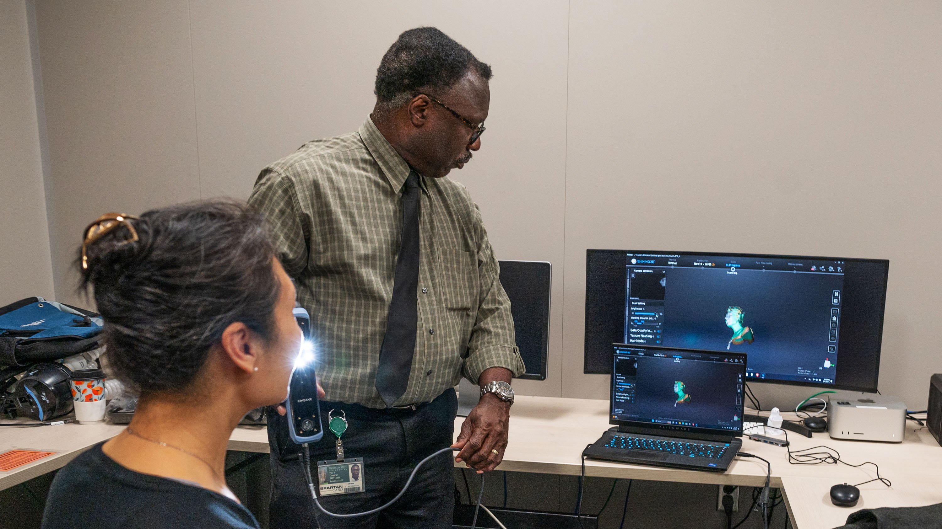 Xiao Gao being scanned with 3D scanner in digital scholarship lab