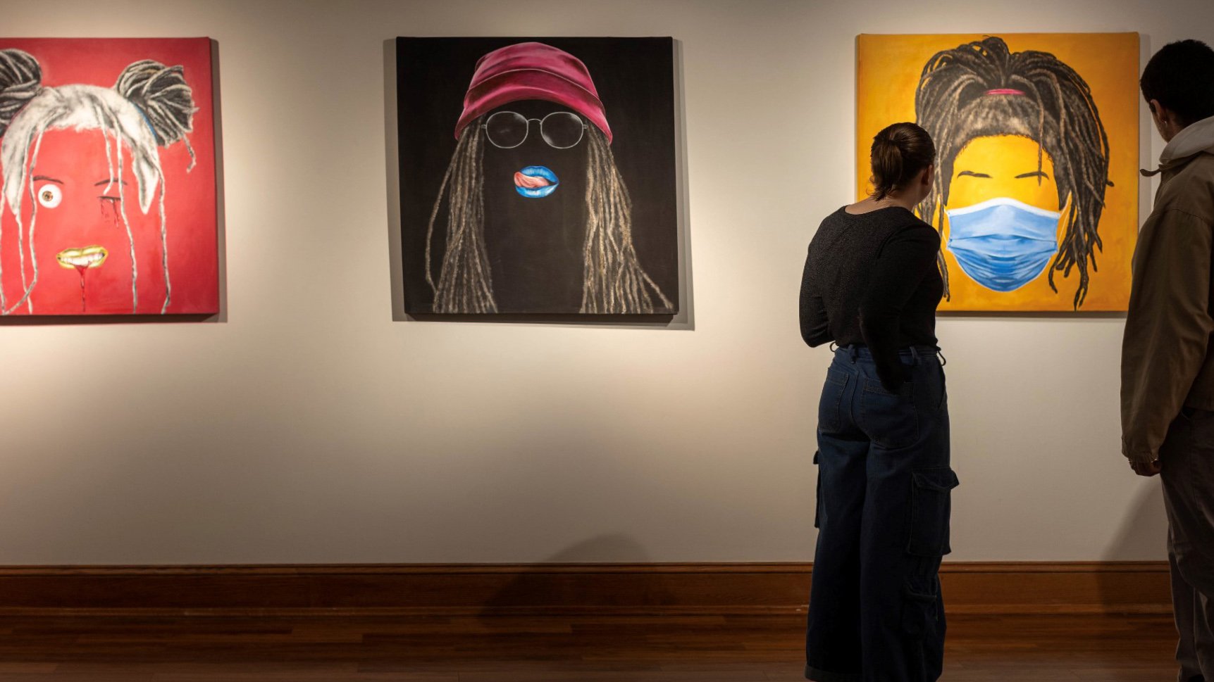 People looking at paintings