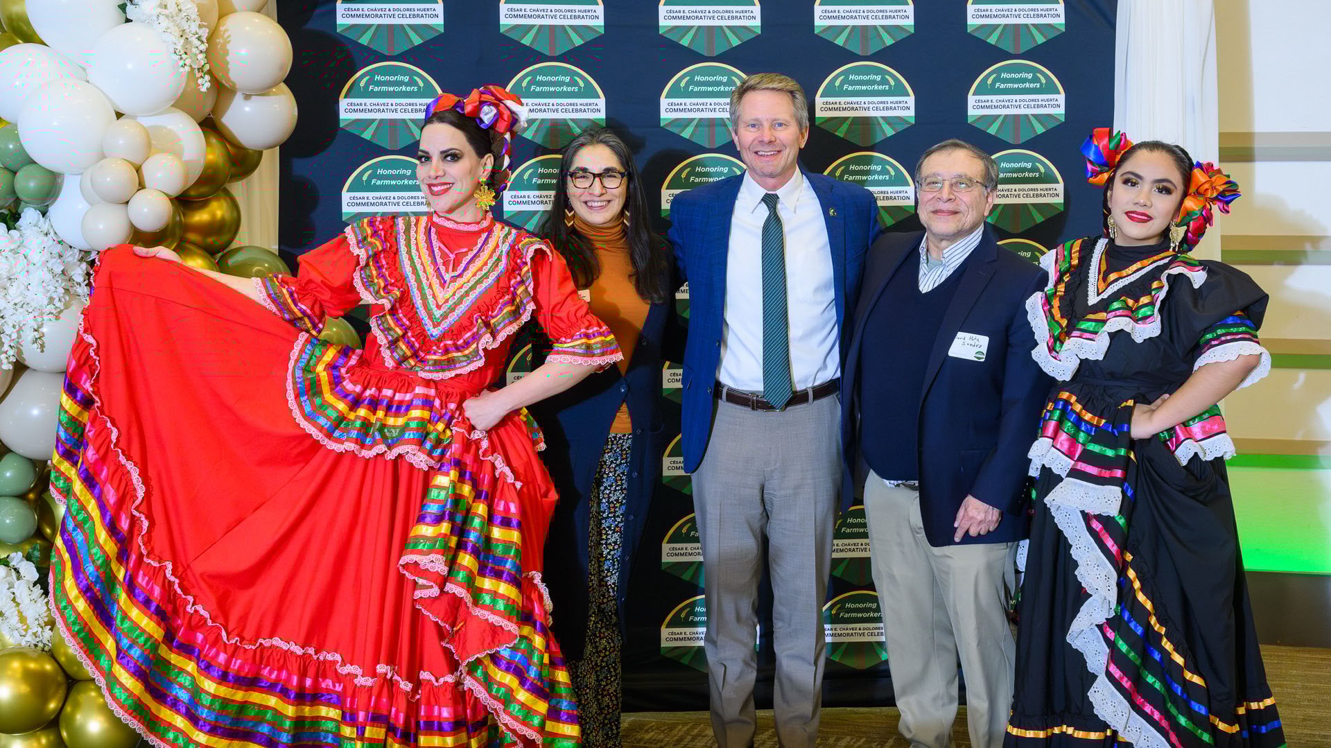 President Kevin Guskiewicz with Ingrid Aguayo-Fuentealba (left) and David Mota-Sanchez (right) and Joyas de Mexico and Folklorico de Wayne State University dancers at the C?sar Ch?vez and Dolores Huerta Celebration