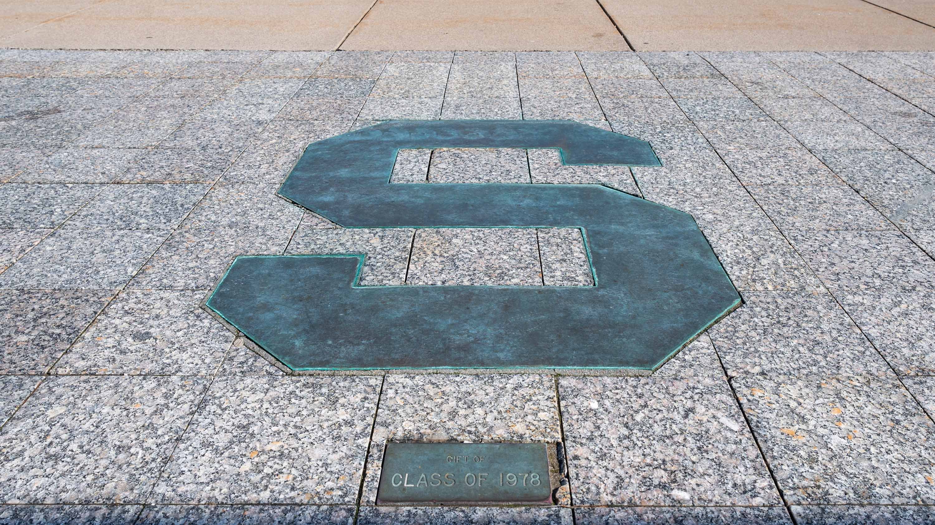 Bronze S in front of Hannah Admin