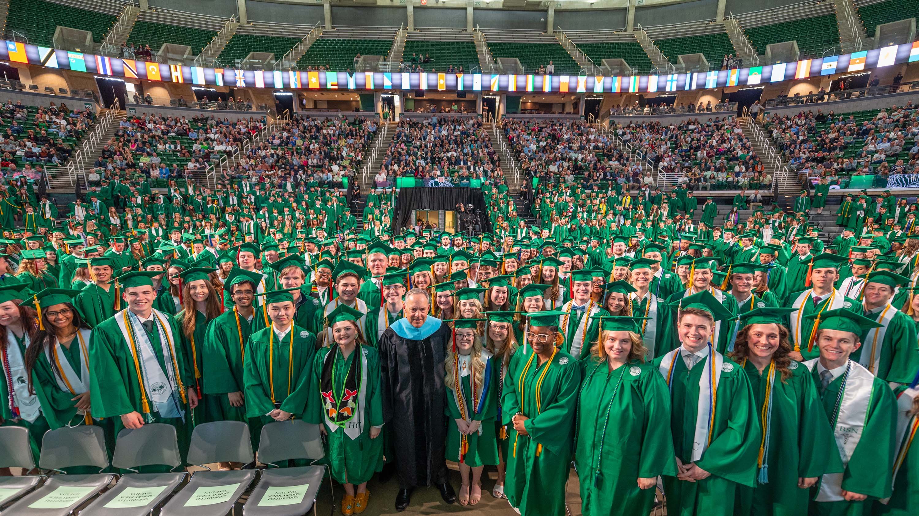 Mark Dantonio with graduates in Breslin Center