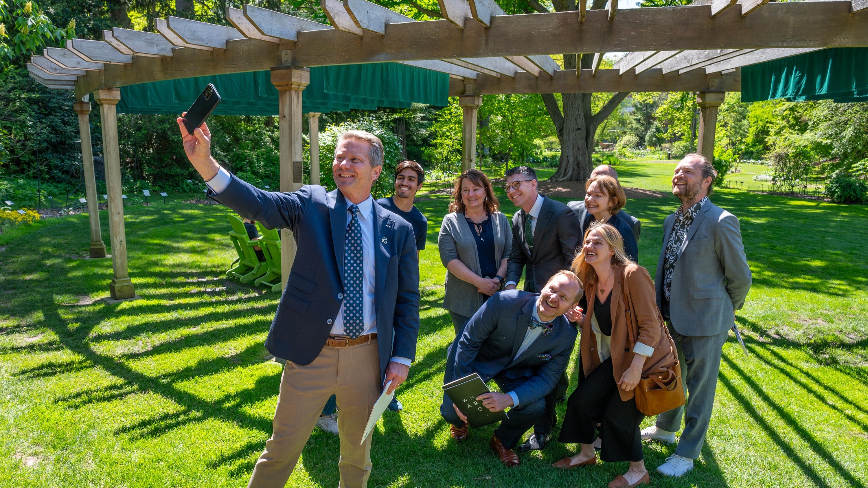 Kevin Guskiewicz taking selfie with others in Beal Garden