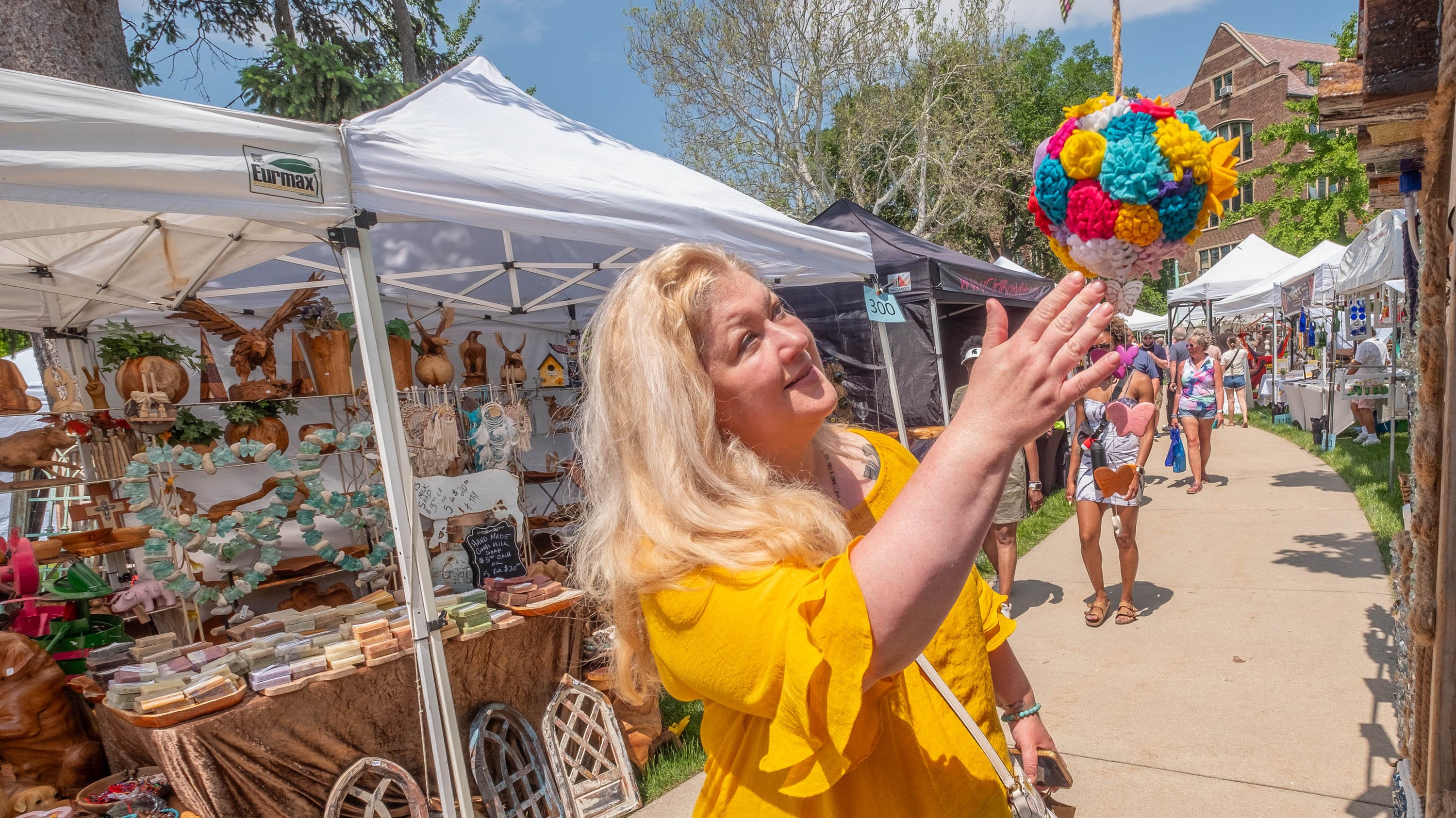 Person looking at a piece of art at Arts and Crafts show