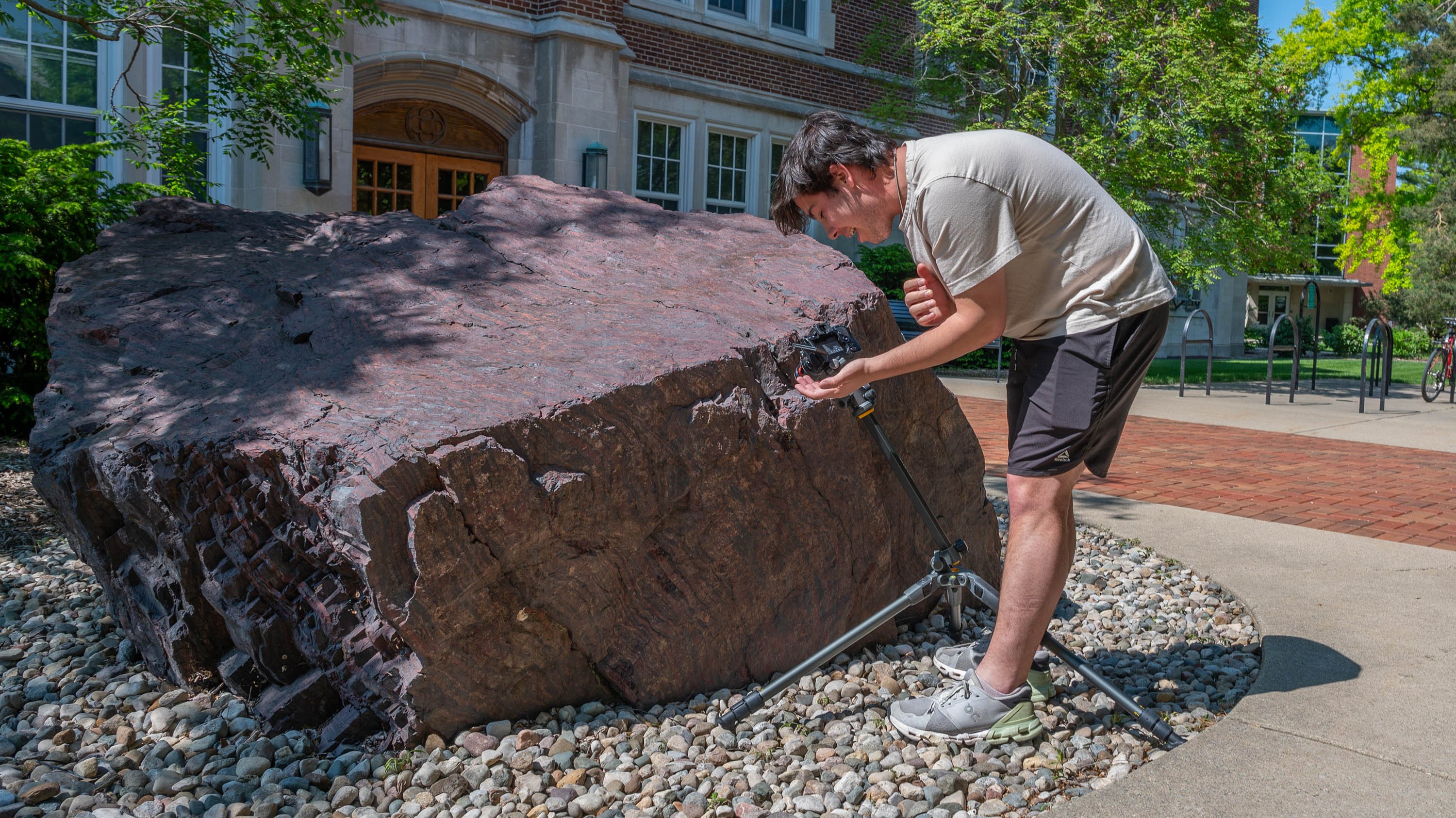 Finn Gomez taking pictures of a rock