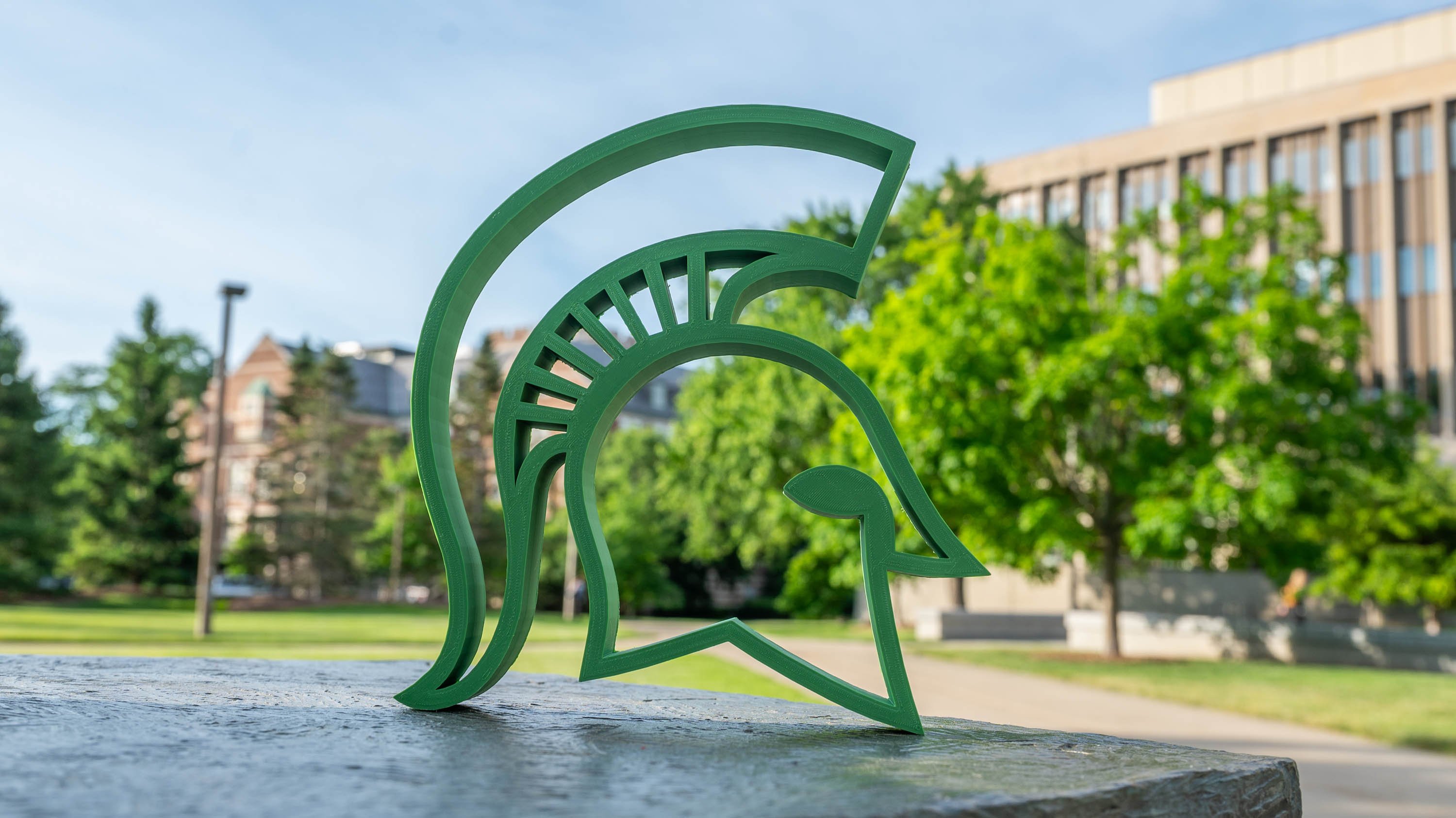3D print of Spartan helmet in front of Hannah Admin Building